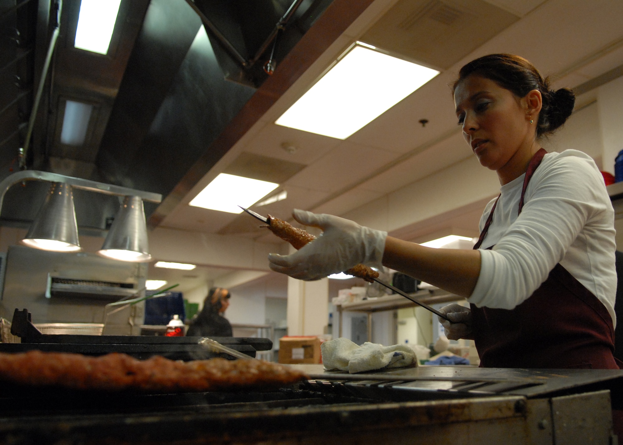 VANDENBERG AIR FORCE BASE, Calif. -- During three days of extensive preparation, Sakine Luzero puts the finishing touches on a traditional Turkish food item, the Adana Kabob, the main dish for the Passport to Turkey held here Friday, Nov. 6, 2009.The festivities were all a part of the event held at the Pacific Coast Club which included traditional Turkish food, tribal belly dancing and music. (U.S. Air Force photo/Airman 1st Class Angelina Drake)