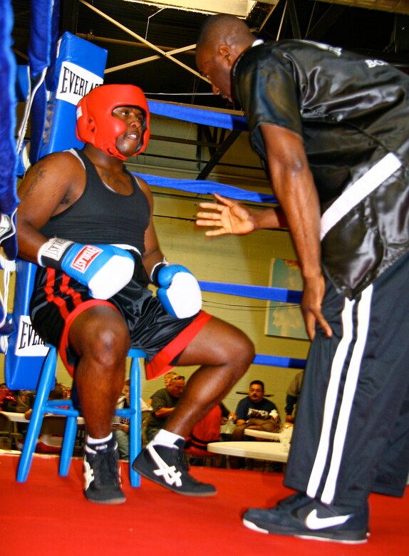 Tinker assistant boxing coach Torraine Smith gives fighter Michael Baker some tips between rounds during the Nov. 7 bout in Tulsa. Baker, an Army Soldier stationed at Fort Sill, Okla., bested his opponent in his second ever USA Boxing league bout. (Air Force photo by John Stuart) 