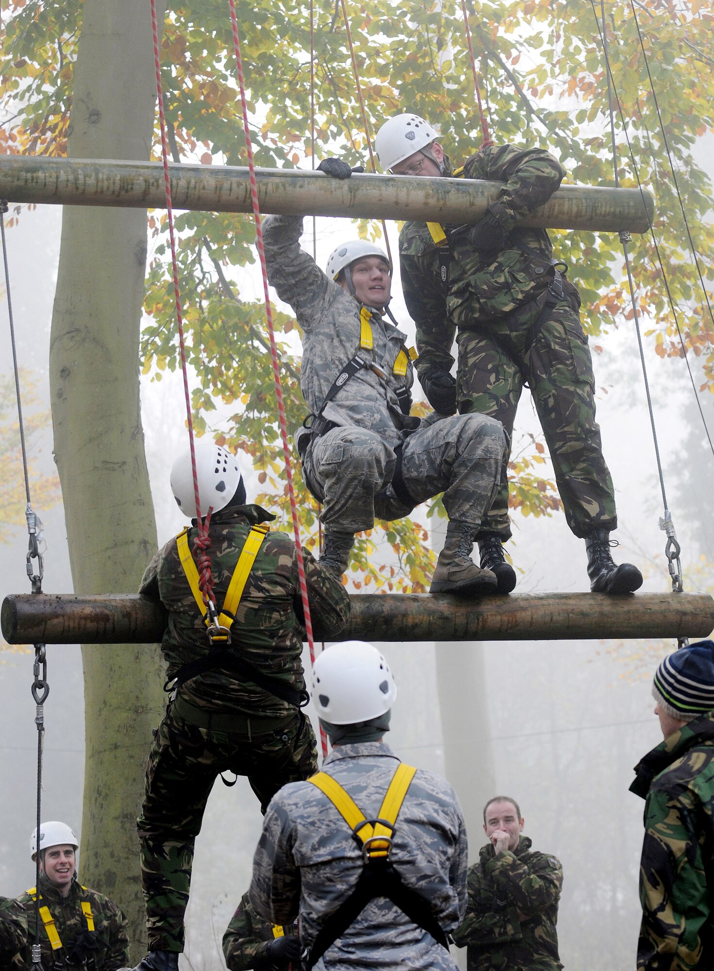 Tech. Sgt. Jason Conley (second from top) participates in the high-ropes course at Royal Air Force Marham with British airmen as part of the RAF's Leadership, Ethos and Air Power Day Nov. 9, 2009.  Forty U.S. Airmen from RAFs Mildenhall and Lakenheath joined the exercise to build relationships and share leadership techniques. Sergeant Conley is from the 48th Medical Support Squadron. (U.S. Air Force photo/Senior Airman Thomas Trower) 