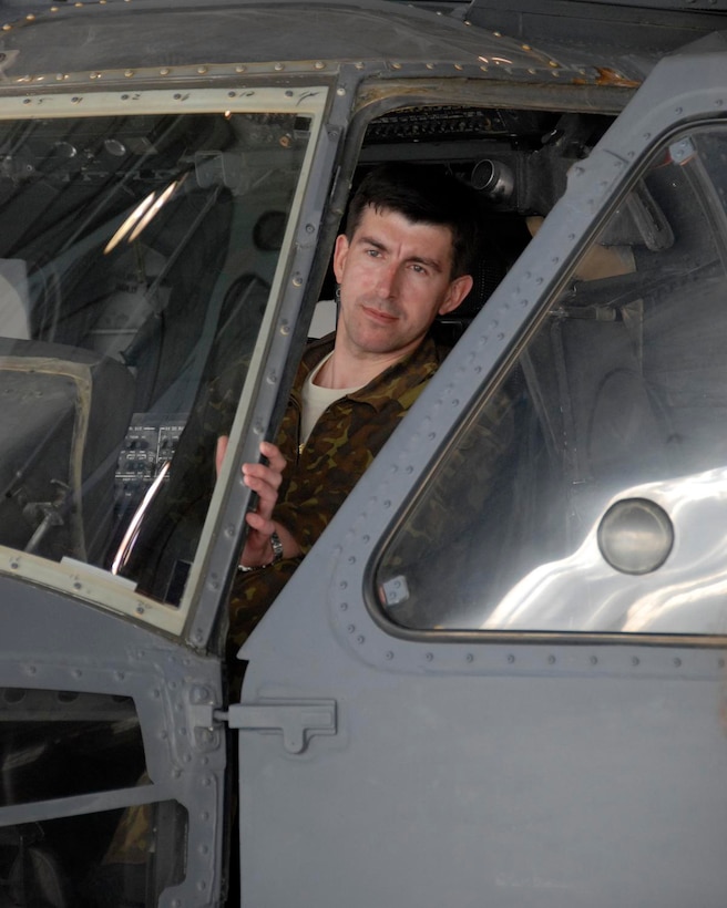 Colonel Victor Gamora, Ukrainian Air Force Command, deputy chief of staff, sits in an HH-60G Pave Hawk helicopter during his tour of the 129th Rescue Wing at Moffett Federal Airfield, Calif., Nov. 5.  Five Ukrainian officers visited California as part of the State Partnership Program. (Air National Guard photo by Staff Sgt. Kim Ramirez/Released)