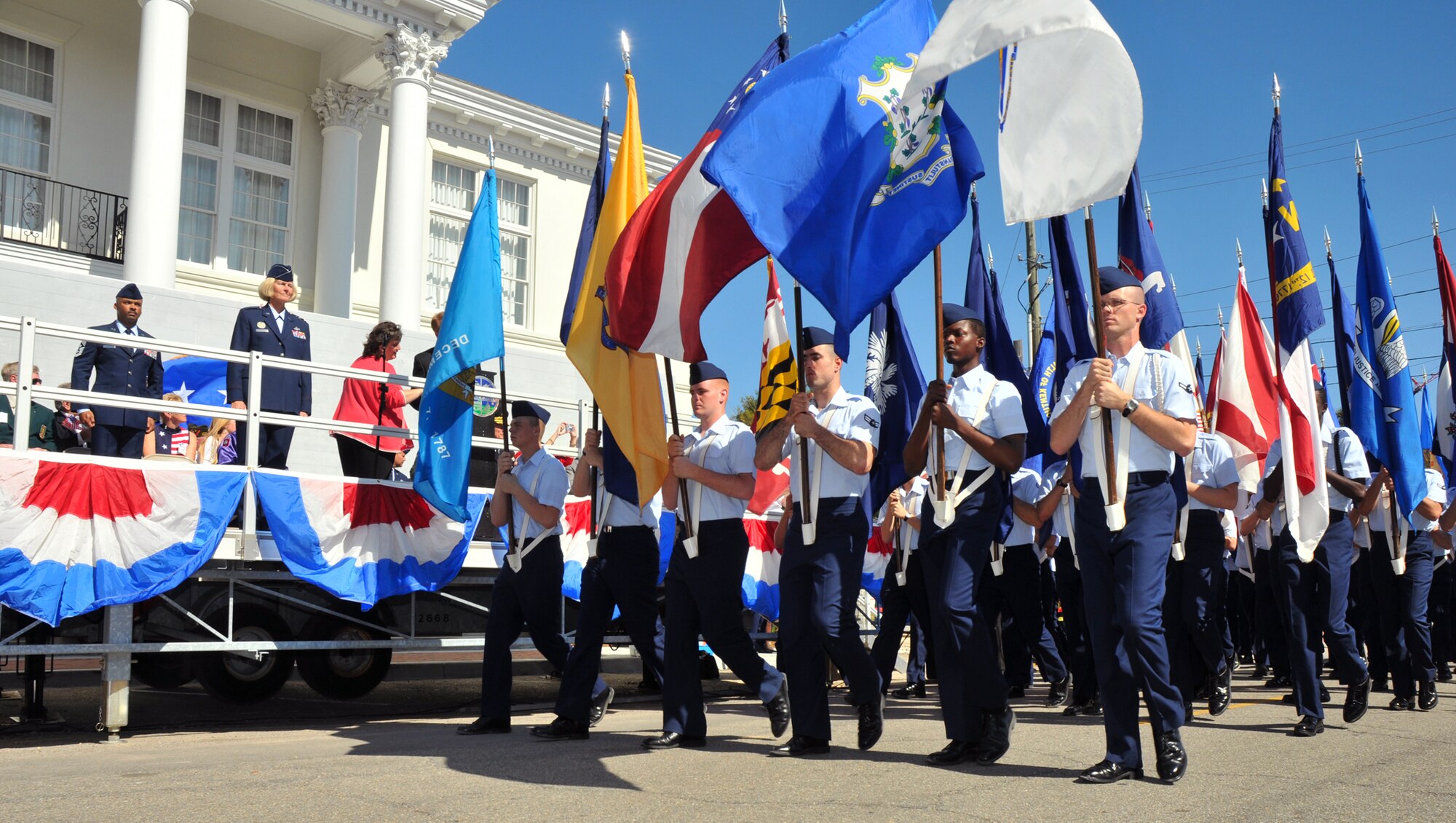 From left, Chief Master Sgt. Linus Jordan, command chief, and Maj. Gen. Mary Kay Hertog, commander, both representing 2nd Air Force, stand at attention as the 50-state flag team from the 332nd Training Squadron marches past the reviewing stand at the 9th annual Gulf Coast Veterans Parade in Gulfport Saturday.  Other senior leaders marching with Team Keesler members included Brig. Gen. Ian Dickinson, commander, and Chief Master Sgt. Lonnie Slater, 81st Training Wing; Brig. Gen. (Dr.) Dan Wyman, commander, and Chief Master Sgt. Michael Anderson, superintendent, 81st Medical Group; Col. Jeff Jackson, commander, and Chief Master Sgt. Laurence Rhoades, superintendent, 81st Mission Support Group; and Lt. Col. Ray Adams, deputy commander, and Chief Master Sgt. Mark McEuen, superintendent, 81st Training Group.  The drum and bugle corps also participated.  (U.S. Air Force photo by Adam Bond)