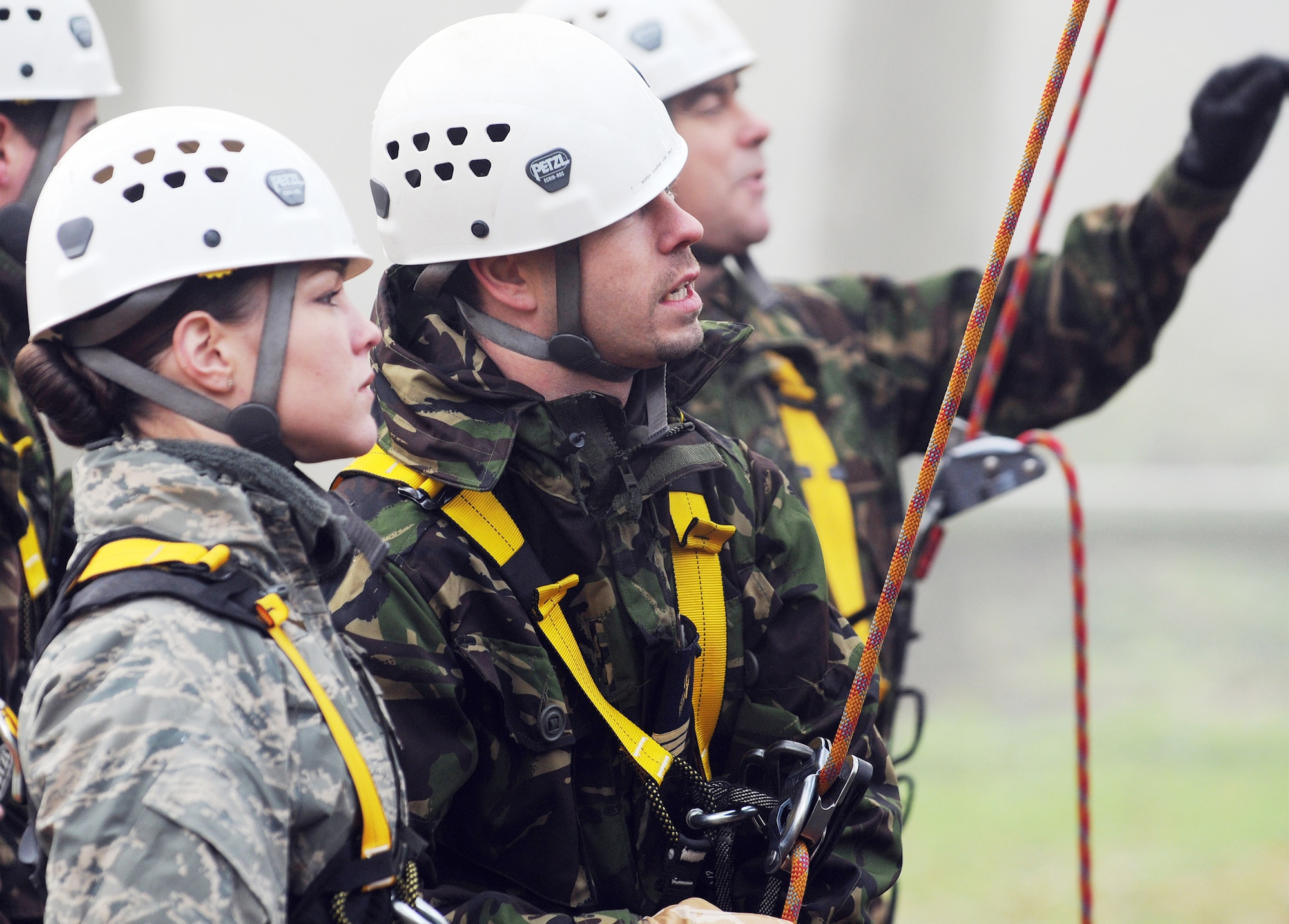 Staff Sgt. Samantha Webb talks with a British airman at the high-ropes course at Royal Air Force Marham Nov. 9, 2009. The Airmen were participants of Leadership, Ethos and Air Power Day, a leadership building event hosted by the camp three times a year. About 40 U.S. Airmen from RAFs Mildenhall and Lakenheath were invited to attend the teambuilding activities. Sergeant Webb is from the 48th Security Forces Squadron. (U.S. Air Force photo/Senior Airman Thomas Trower)