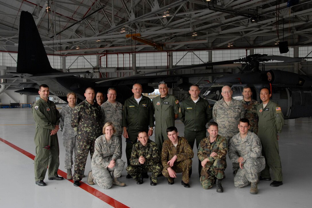 Ukrainian Air Force officers  pose with 129th Rescue Wing members during their tour of the 129th at Moffett Federal Airfield, Calif., Nov. 5. The Ukrainians visited California as part of the State Partnership Program. (Air National Guard photo by Staff Sgt. Kim Ramirez/Released)