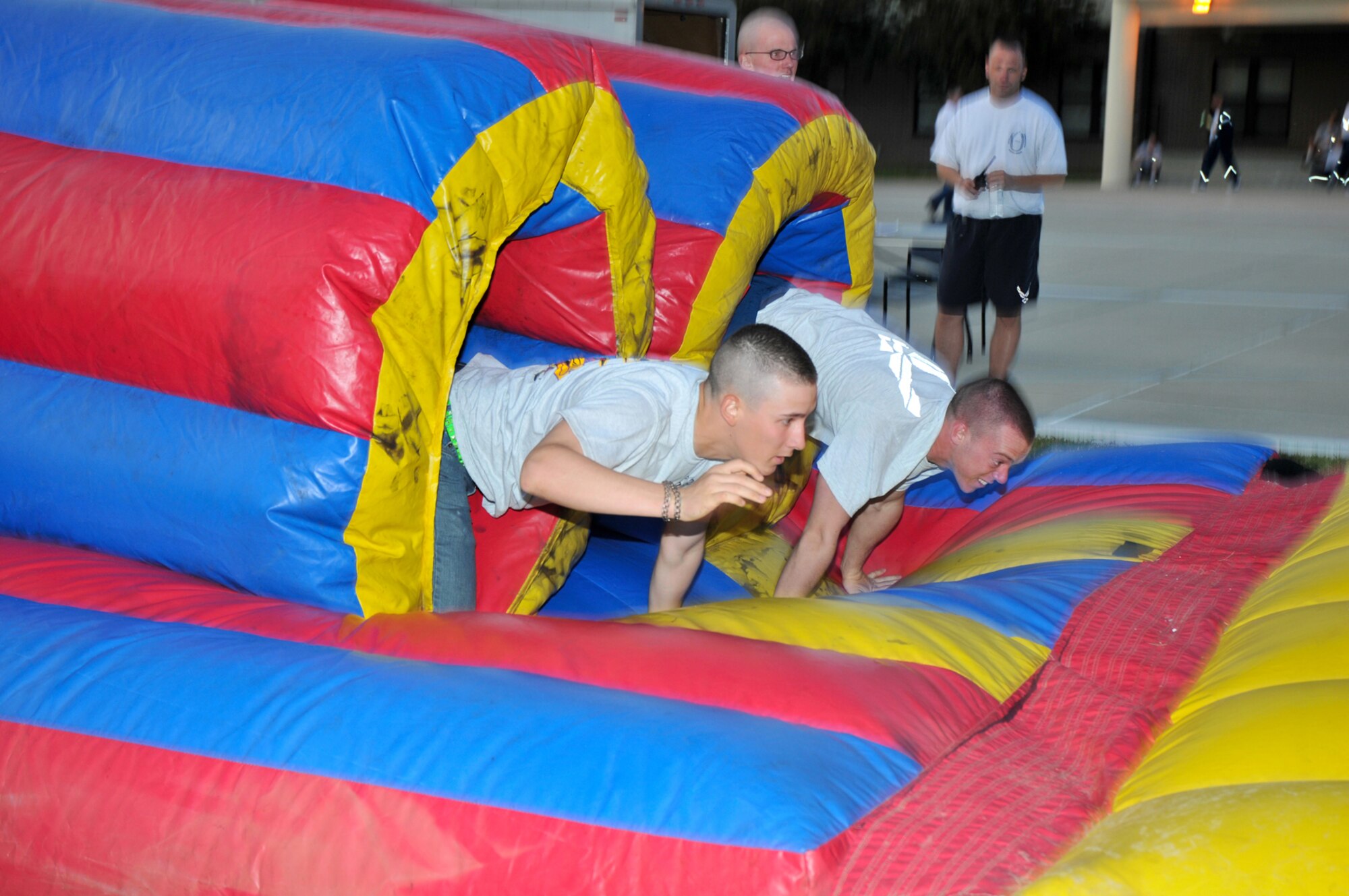 Airmen Basic Alexander Repic, left, 338th Training Squadron, and Brent Wilcoxson, 332nd TRS, battle for the lead in the obstacle course during Saturday’s Keesler Wipeout for nonprior service students from the 81st Training Group.  (U.S. Air Force photo by Adam Bond)