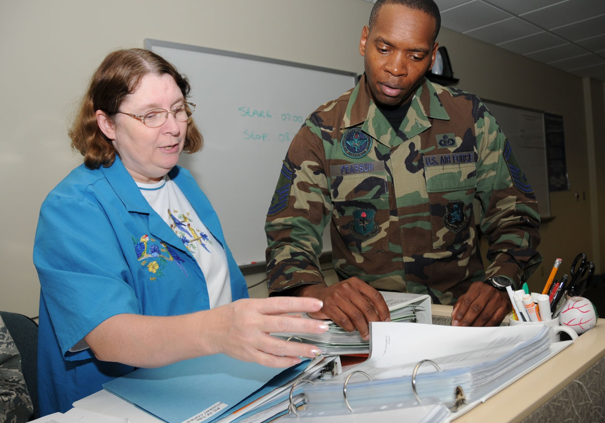 Ms. Funk and Sergeant Pearson review paperwork for the 334th TRS aviation resource management apprentice course.  (U.S. Air Force photo by Kemberly Groue)