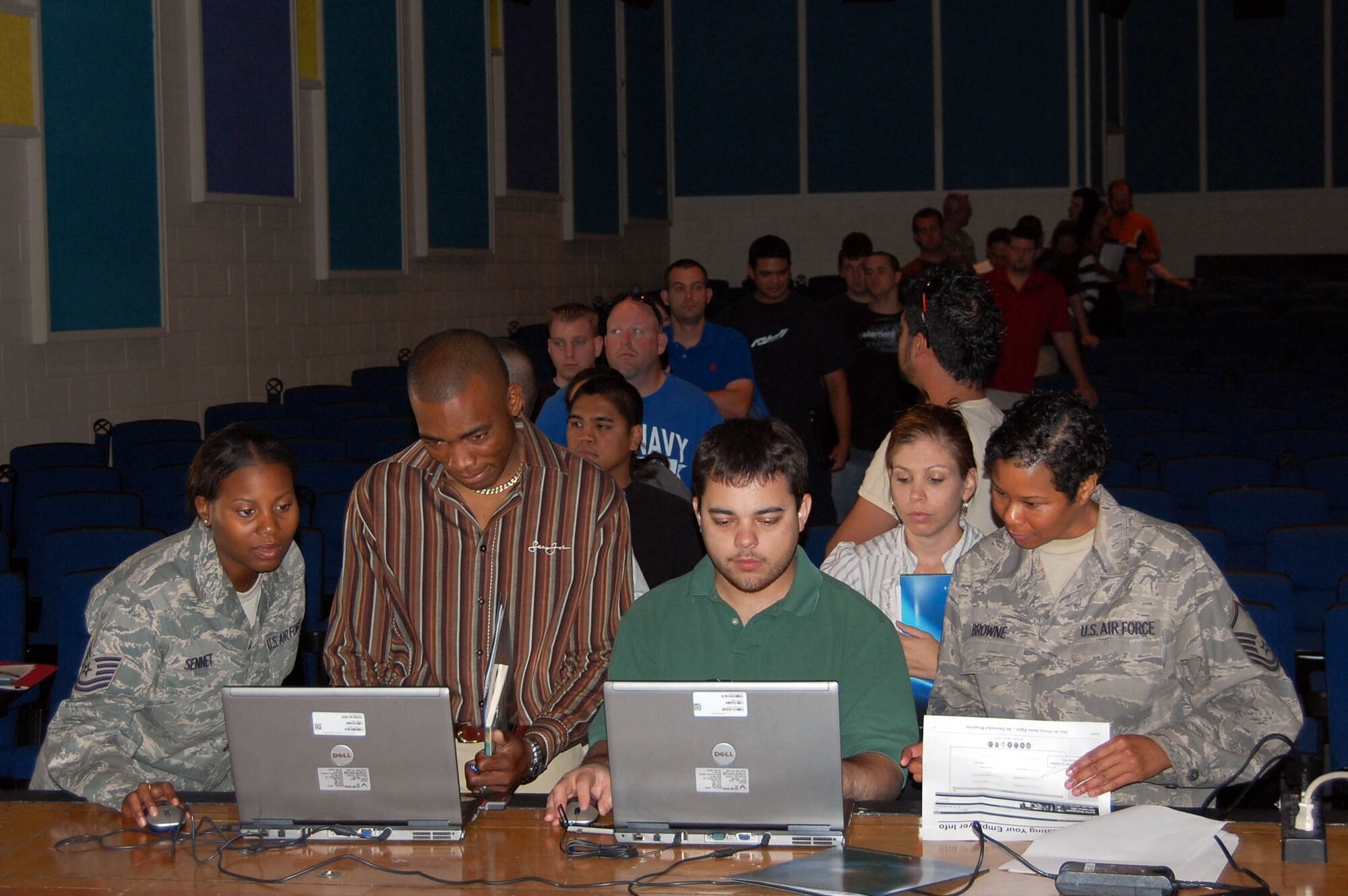 Tech. Sgt. Vickie Sennet (left) and Master Sgt. Simone Browne, 926th Mission Support Squadron computer support administrators, assist Individual Ready Reserve members with updating their Civilian Employment Information. More than 60 IRR members attended the first Enhanced Muster in Air Reserve Personnel Command held at Nellis Air Force Base, Nev., on Nov. 6.