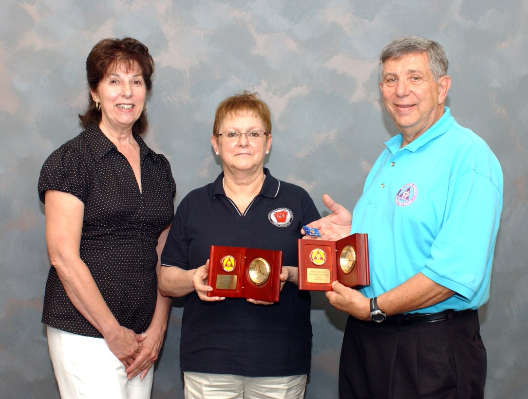 During the general session held July 27 at the National Guard Family
Program Volunteer Workshop in Dearborn, Michigan, General Craig R. McKinley,
chief of the National Guard Bureau presented Family Program Volunteer
awards to Mrs. Blank and Chief Moretti for their dedication and countless
volunteer hours.  Shown are: Jean Moretti, 111th Family Readiness Group coordinator; Sarah Blank, former FRG president; and Chief Master Sgt. (Ret) John Moretti.