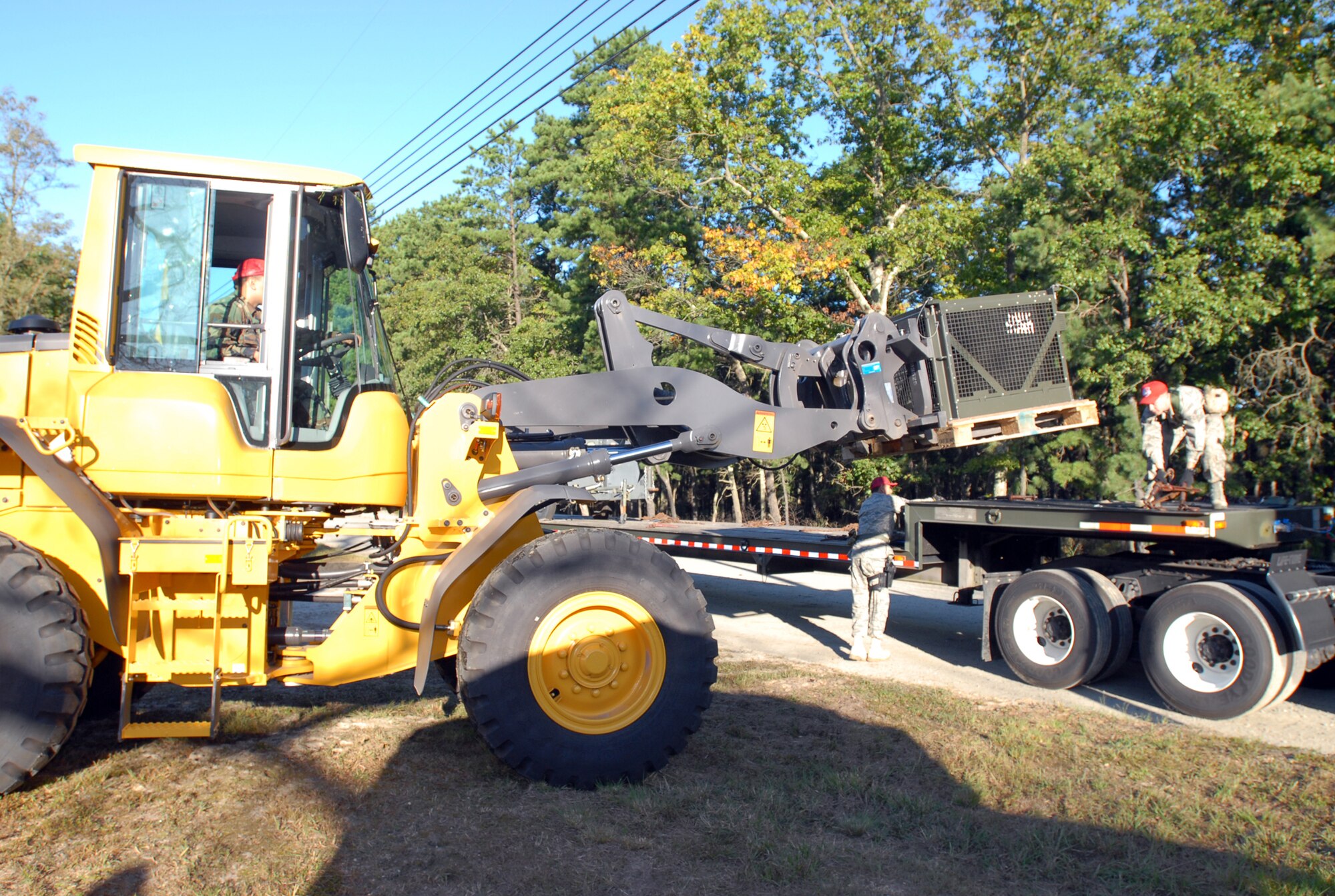Members of the 201st RED HORSE Squadron Detachment 1 load an environmental control unit onto a flatbed trailer during a field training exercise held Sept. 19 at Fort Dix, NJ.