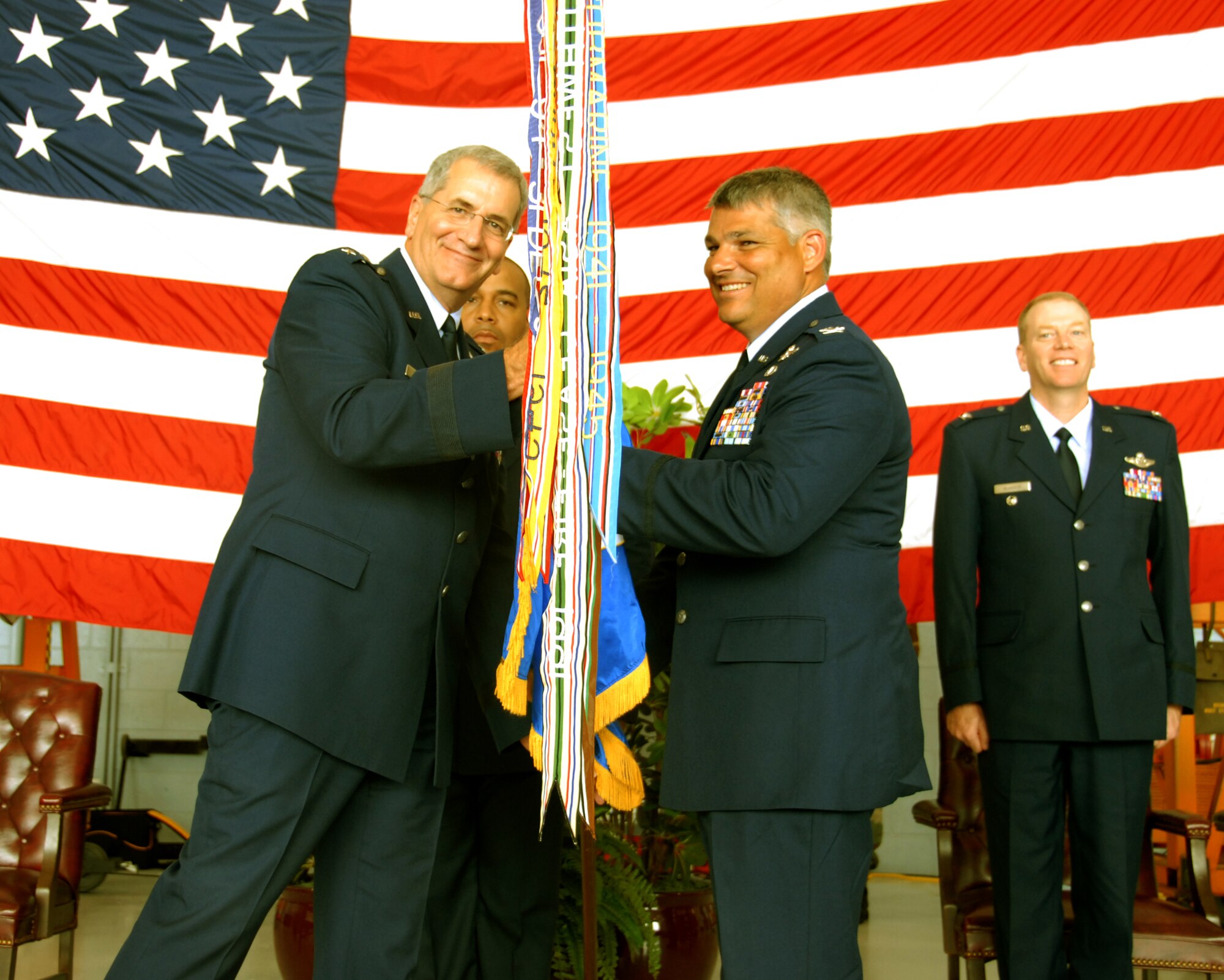 Col. Tony Carrelli, 111th Maintenance Group commander, receives the guideon from Maj. Gen. Stephen M. Sischo, Deputy Adjutant General-Air and Commander of the Pa. Air National Guard and assumes command of the 111th Fighter Wing during a change of command ceremony held Aug. 2 at Willow Grove Air Reserve Station, Pa.