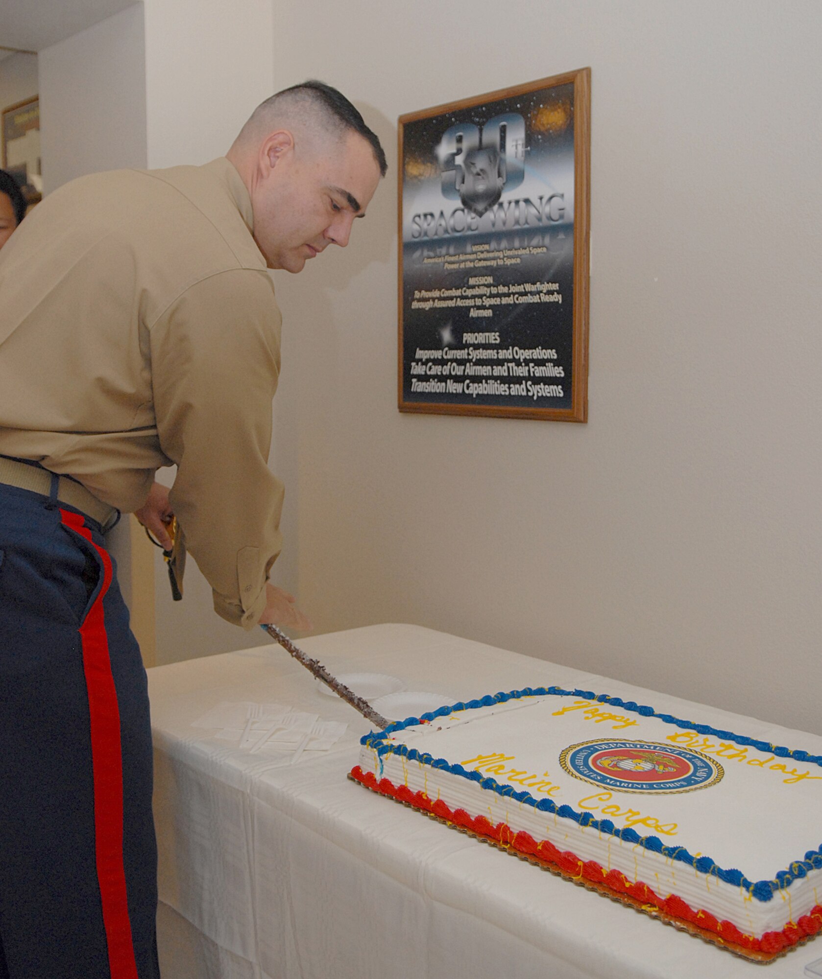VANDENBERG AIR FORCE BASE, Calif. -- Lt. Col Jeffery Miller, a space planner for the Joint Functional Component Command for Space cuts a cake at a celbration for the Marine Corps' 234th birthday cake Tuesday, Nov. 10, 2009 here. The Marine Corps is the oldest branch of service in the U.S. military. (U.S. Air Force photo/Airman 1st Class Kerelin Molina)