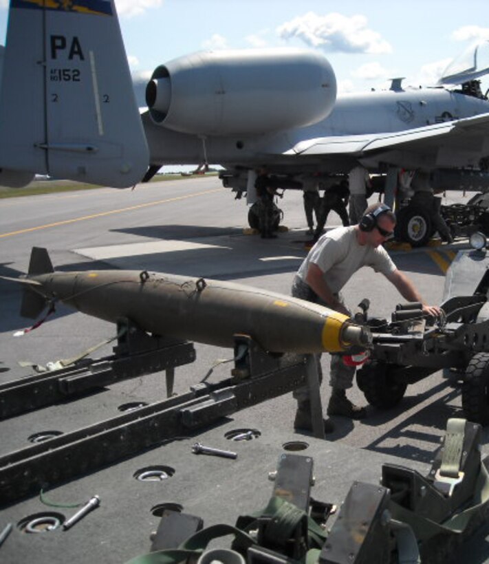 Tech. Sgt. Dennis L. Donahue, 111th Aircraft Maintenance Squadron, Pa. Air National Guard, preps a live MK-82 low drag bomb before it is lifted and attached to an A-10 aircraft, during live loading operations at Fort Drum, NY.