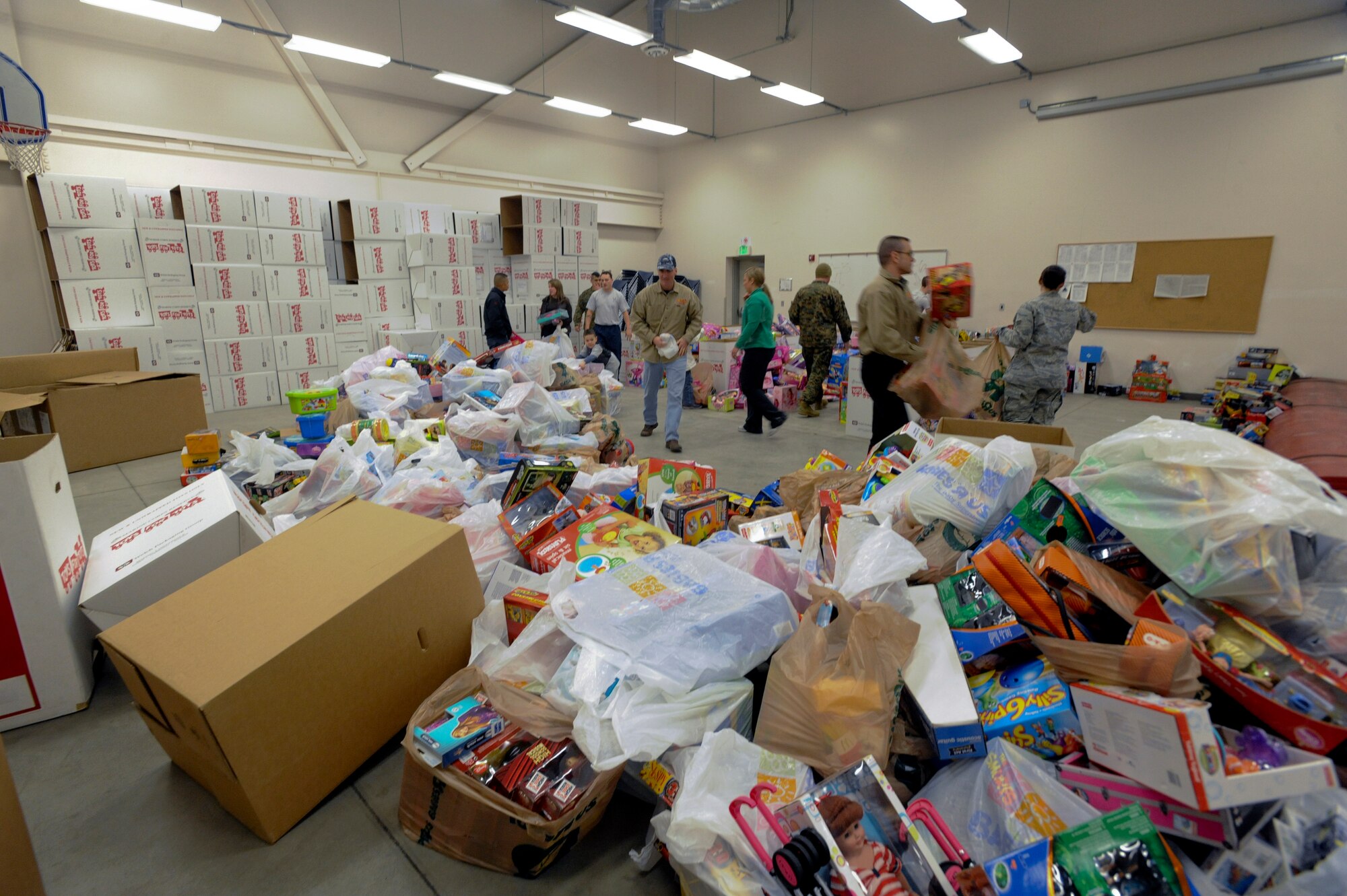 ELMENDORF AIR FORCE BASE, Alaska -- Volunteers separate toys into age groups at the United States Marine Corps' Reserve Training Center after purchasing them from Toys R' Us.  All the toys that the Marines collect during the Toys for Tots drive will be sorted and pre-staged to be delivered to children in remote villages around Alaska. (U.S. Air Force Photo/ Staff Sgt. Joshua Garcia)