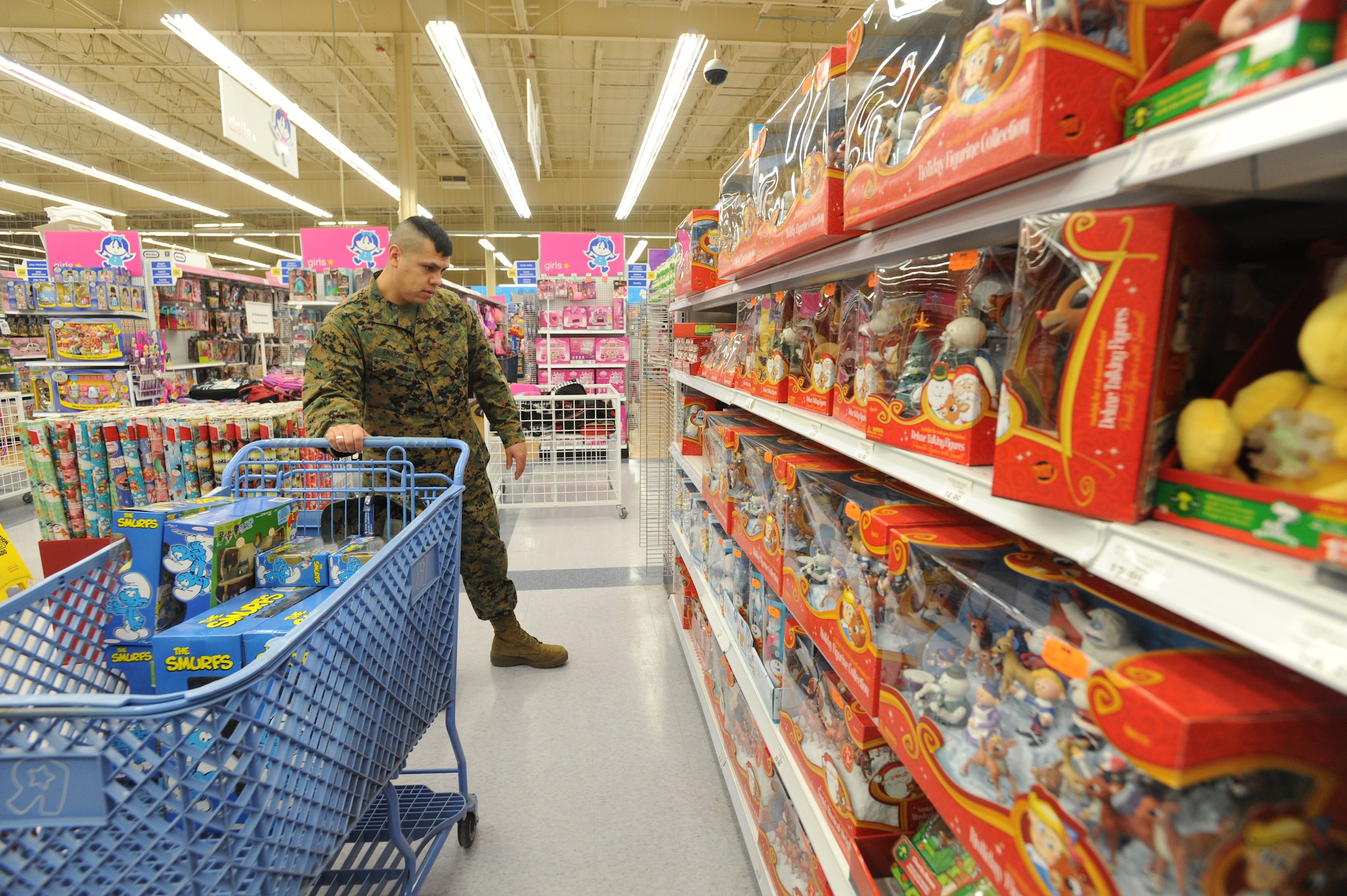 ANCHORAGE, Alaska -- United States Marine Corps Staff Sergeant Manuel Enriquez, Company D (-), Anti-Terrorism Battalion, selects toys at Toys R' Us during a mass purchase for "Toys for Tots". All the toys that the Marines collect during the Toys for Tots drive will be sorted and pre-staged to be delivered to children in remote villages around Alaska. (U.S. Air Force Photo/ Staff Sgt. Joshua Garcia)