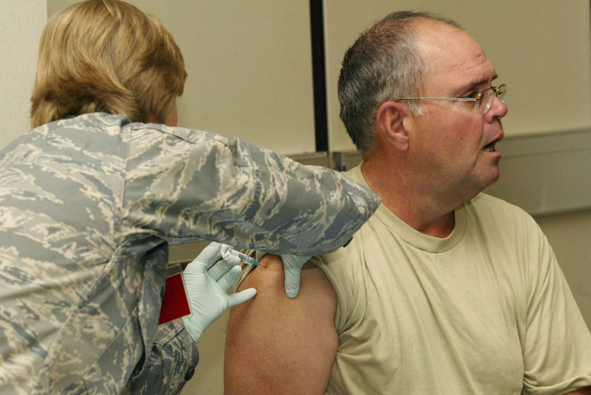 Master Sgt. David Williams, 80th Aerial Port Squadron, receives his flu vaccination in the form of an arm injection at the base wide flu immunization program held at the 22nd Air Force Headquarters building Nov. 7. (U.S. Air Force photo/Don Peek)