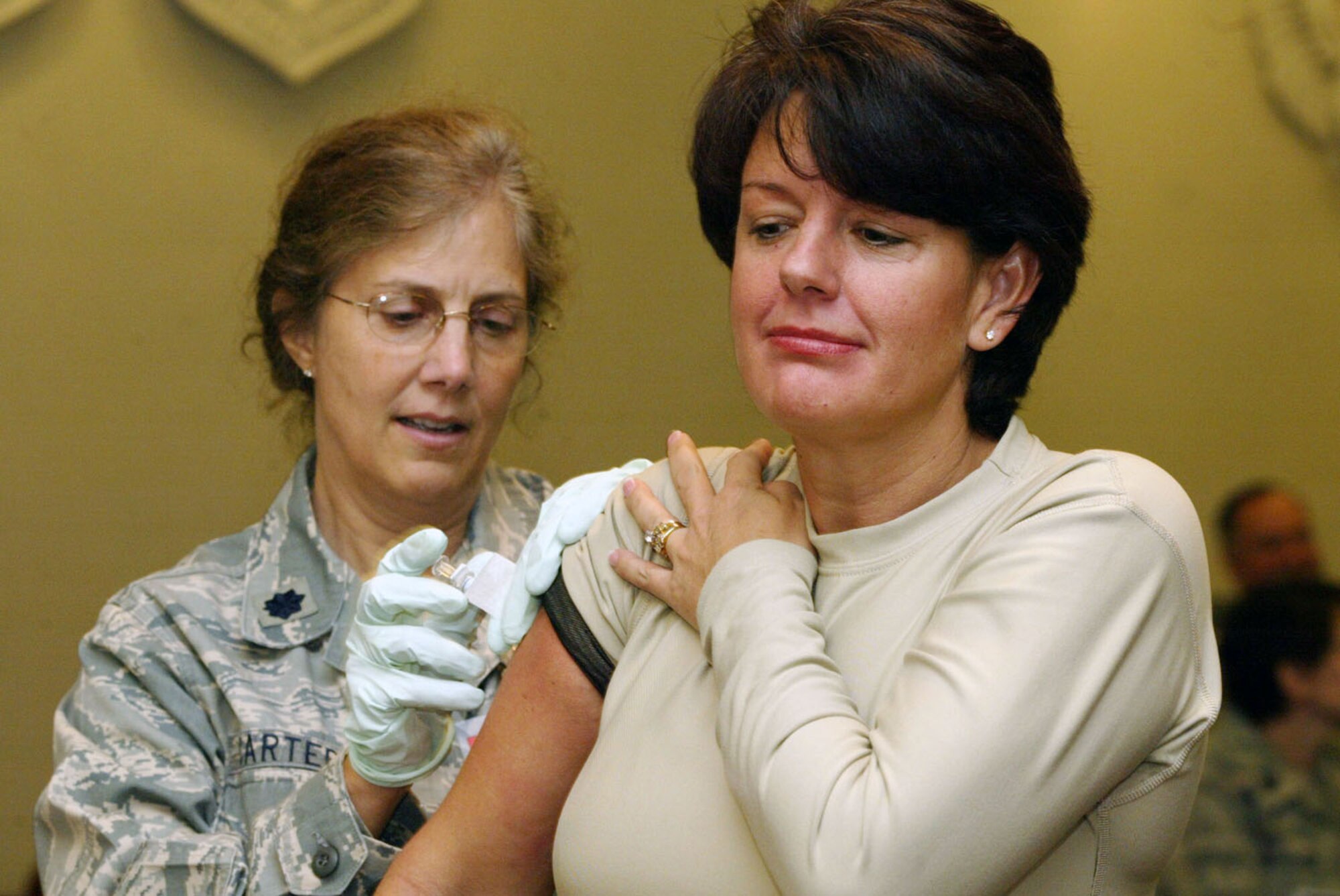 Lt. Col. Jan Carter from the 94th Aeromedical Staging Squadron gives a flu shot vaccine injection to Chief Master Sgt. Patricia Alongi-Snyder from the 22nd Air Force at the base wide flu immunization program held at the 22nd Air Force Headquarters building Nov. 7. (U.S. Air Force photo/Don Peek)