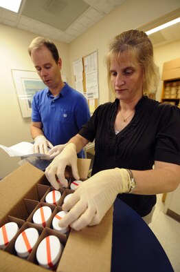 MINOT AIR FORCE BASE, N.D. -- Mrs. Lisa Peckham, the drug demand reduction program manager and Mr. Vince Tomasi, the drug testing program administration manager, both members of the 5th Medical Operations Squadron behavioral health flight, verify specimen bottles here Nov 3. The two were instrumental to the 5th Medical Group meeting requirements of the Air Force Healthcare mission. The medical group recently completed an Air Force Inspection Agency Health Services Inspection and captured an overall excellent rating. (U.S. Air Force photo by Tech. Sgt. Lee A. Osberry Jr.)