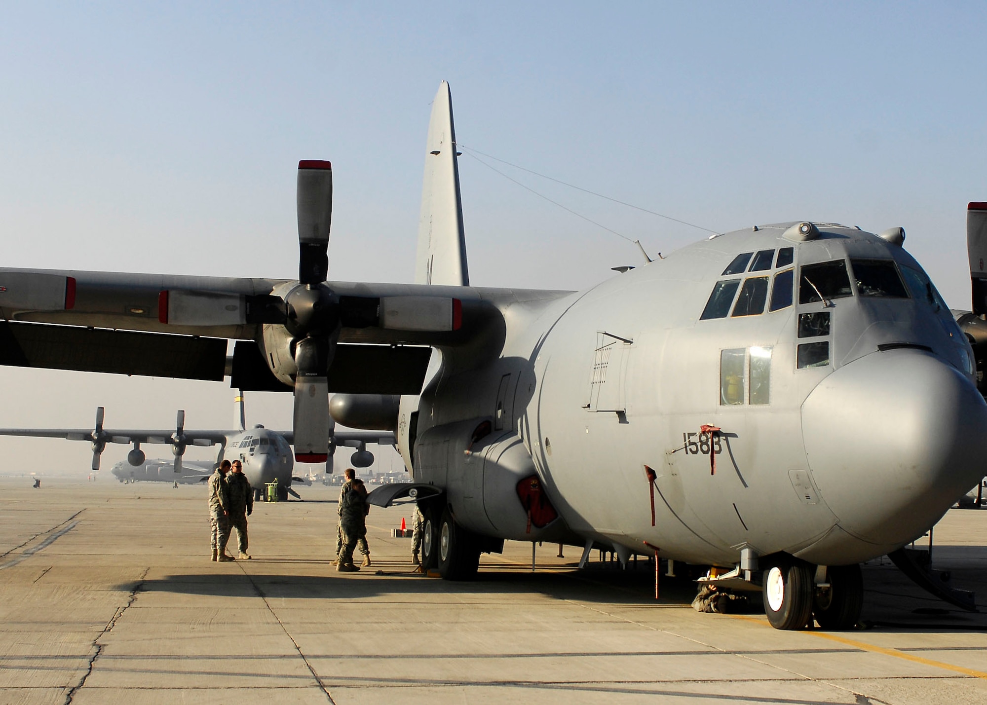 BAGRAM AIRFIELD, Afghanistan -- Airmen from the 41st Expeditionary Electronic Combat Squadron perform an inspection of the EC-130 Compass Call Nov. 12, 2009.  These inspections are important because the EC-130s primary mission is to support tactical air operations, but also can provide jamming support to ground forces in support of Operation Enduring Freedom.  The Compass Call system employs offensive capabilities in support of U.S. and Coalition tactical air, surface, and special operations forces.  (U.S. Air Force photo/Senior Airman Felicia Juenke)