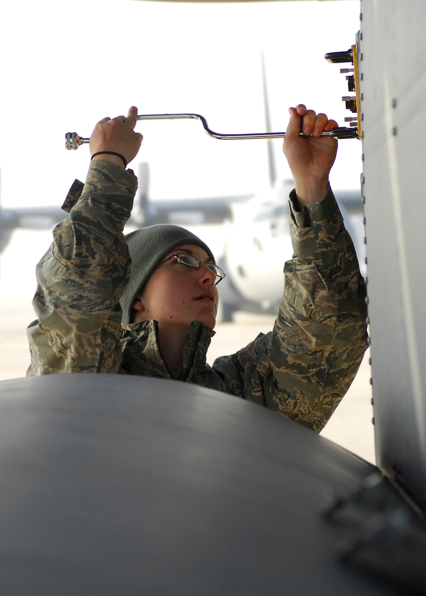 BAGRAM AIRFIELD, Afghanistan -- Airman First Class Sarah Garrett, an electronic warfare specialist from the 41st Expeditionary Electronic Combat Squadron, takes the power unit off of the EC-130 Compass Call Nov. 12, 2009.  The Compass Call system employs offensive capabilities in support of U.S. and Coalition tactical air, surface, and special operations forces.  Airman Garrett is deployed from Davis-Monthan Air Force Base, Ariz., and hails from Alamogordo, N.M.  (U.S. Air Force photo/Senior Airman Felicia Juenke)