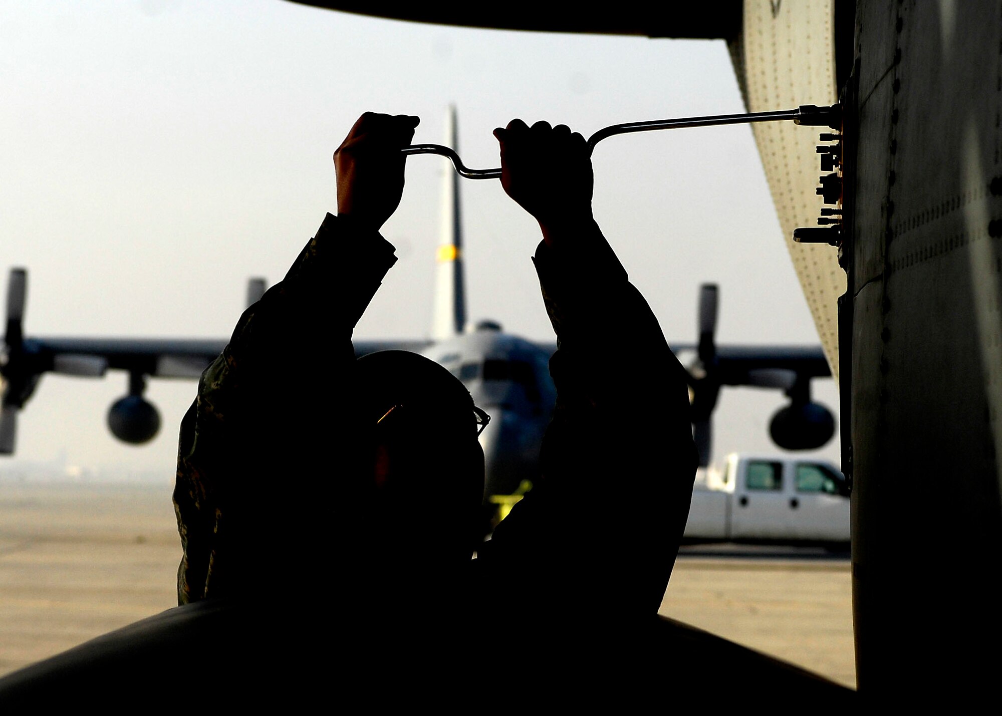 BAGRAM AIRFIELD, Afghanistan -- Airman First Class Sarah Garrett, an electronic warfare specialist from the 41st Expeditionary Electronic Combat Squadron, takes the power unit off of the EC-130 Compass Call Nov. 12, 2009.  The Compass Call system employs offensive capabilities in support of U.S. and Coalition tactical air, surface, and special operations forces.  Airman Garrett is deployed from Davis-Monthan Air Force Base, Ariz., and hails from Alamogordo, N.M.  (U.S. Air Force photo/Senior Airman Felicia Juenke)
