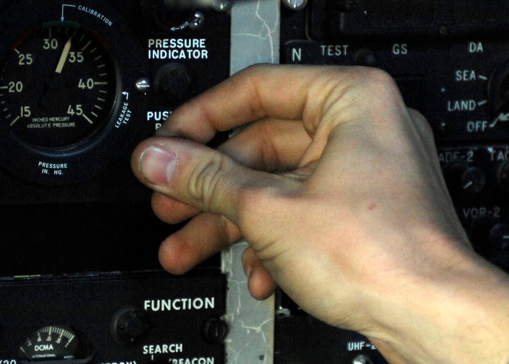 BAGRAM AIRFIELD, Afghanistan -- Senior Airman Bob Kaster, a communication navigation specialist from the 41st Expeditionary Electronic Combat Squadron, inspects the equipment at his station in the cockpit of the EC-130 Compass Call Nov. 12, 2009.  The Compass Call system employs offensive capabilities in support of U.S. and Coalition tactical air, surface, and special operations forces.  Airman Kaster, a Woodbury, Minn. native, is deployed from Davis-Monthan Air Force Base, Ariz.  (U.S. Air Force photo/Senior Airman Felicia Juenke)