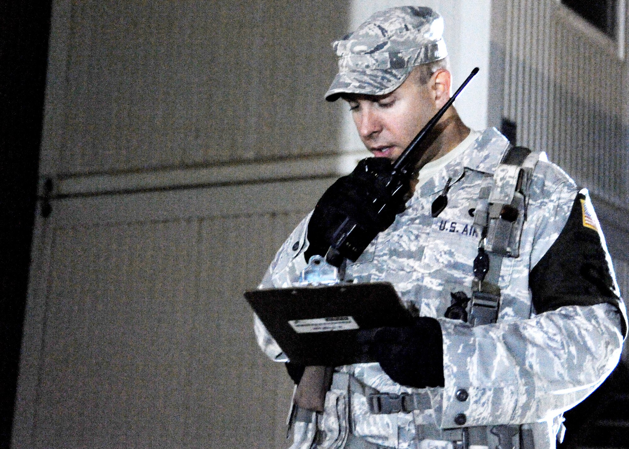 Tech. Sgt. Thomas Williamson keeps radio contact with teams conducting a health and wellness inspection at housing units Nov. 7, 2009, at Joint Base Balad, Iraq. Security personnel conduct health and wellness inspections for a variety of reasons, even as random antiterrorism measures to check for contraband items. Sergeant Williamson is assigned to the 332nd Expeditionary Security Forces Squadron. (U.S. Air Force photo/Senior Airman Christopher Hubenthal)