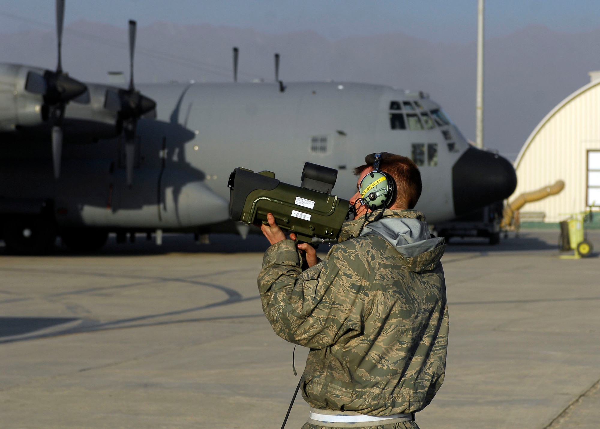 BAGRAM AIRFIELD, Afghanistan -- Airman First Class Michael Walden, a crew chief from the 41st Expeditionary Electronic Combat Squadron, uses an infrared calibrator to assure the IR system is working properly Nov. 12, 2009.  The EC-130H Compass Call system employs offensive capabilities in support of U.S. and Coalition tactical air, surface, and special operations forces.  Airman Walden is deployed from Davis-Monthan Air Force Base, Ariz., and hails from Las Vegas.  (U.S. Air Force photo/Senior Airman Felicia Juenke)