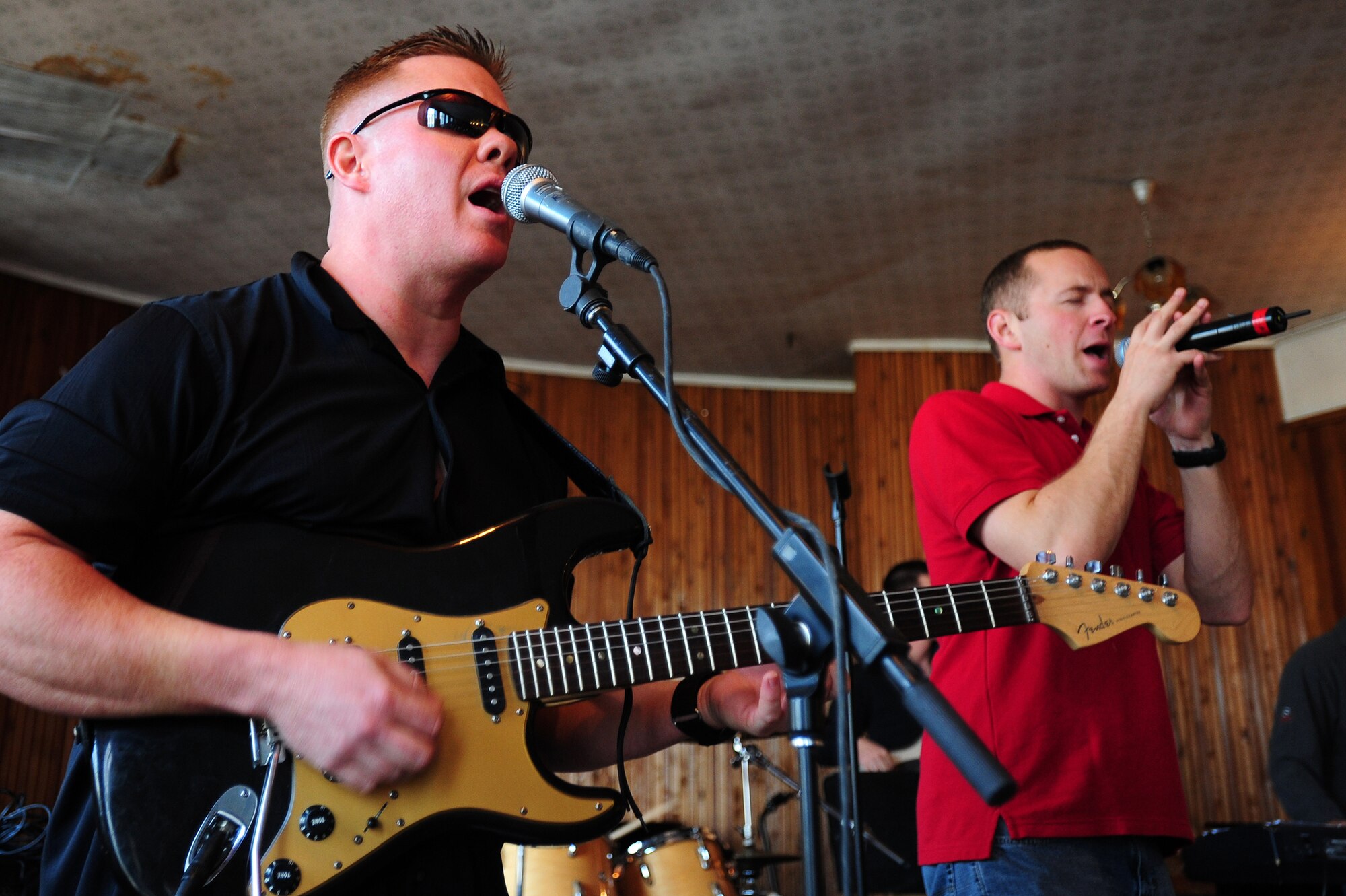 BISHKEK, Kyrgyzstan -- Tech. Sgt. Steve Wilson, U.S. Air Forces Central Sirocco Band guitarist, and Airman 1st Class Clayton Lee, U.S. AFCENT Sirocco Band vocalist, perform at the Abdraev Boarding School of Music, Nov. 12, 2009. The Sirocco Band perform a wide variety of music ranging from modern rock, oldies, and pop. The band members are stationed at a base in Southwest Asia and are deployed from Lackland Air Force Base, Texas. (U.S. Air Force photo/Senior Airman Steele C. G. Britton)