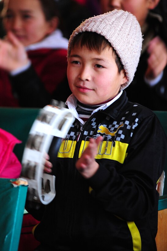 BISHKEK, Kyrgyzstan -- An Abdraev Boarding School of Music student plays along with the U.S. Air Forces Central Sirocco Band during a performance at the school, Nov. 12, 2009. (U.S. Air Force photo/Senior Airman Steele C. G. Britton)