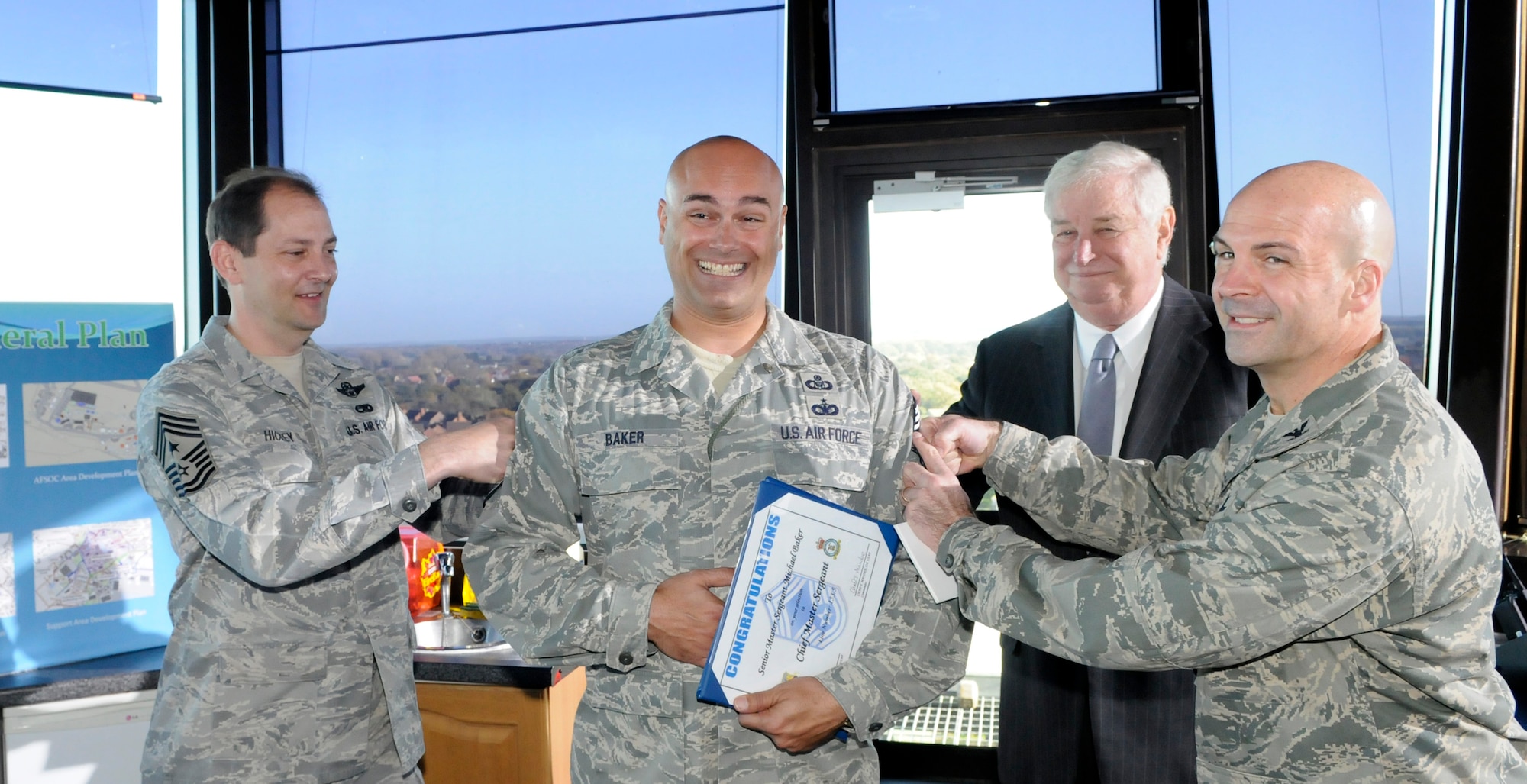 RAF MILDENHALL, England -- Louis Susman, U.S. ambassador to the U.K., Col. Chad Manske, 100th Air Refueling Wing commander and Chief Antonio Hickey, 100th Air Refueling Wing command chief, Promote Senior Master Sgt. Michael Baker, 100th Operations Support Squadron, to Chief Master Sergeant. Nov. 12.  Sergeant Baker was asked to give a last-minute briefing to Ambassador Susman but upon arrival was surprised to find out that he would receive his promotion certificate from the Ambassador. (U.S. Air Force photo/Staff Sgt. Christopher L. Ingersoll)