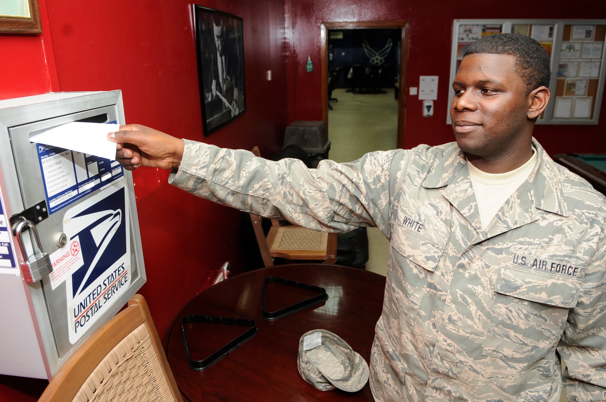 SOUTHWEST ASIA – Senior Airman Kenneth White, 380th Expeditionary Force Support Squadron, puts a letter with “FREE” written on it in a post office receptacle Nov. 12, 2009. Airman White is deployed from the 172nd Airlift Wing, Mississippi Air National Guard Wing, Jackson, Miss., and calls Hattiesburg, Miss., home. (U.S. Air Force photo/Senior Airman Stephen Linch)