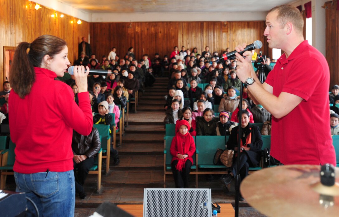BISHKEK, Kyrgyzstan -- U.S. Air Forces Central Sirocco Band Vocalists Tech. Sgt. Christin Foley and Airman 1st Class Clayton Lee sing a duet for an audience at the Abdraev Boarding School of Music, Nov. 12, 2009. The Sirocco Band performs a wide variety of music ranging from modern rock, oldies, and pop. The band members are stationed at a base in Southwest Asia and are deployed from Lackland Air Force Base, Texas. (U.S. Air Force photo/Senior Airman Steele C. G. Britton)
