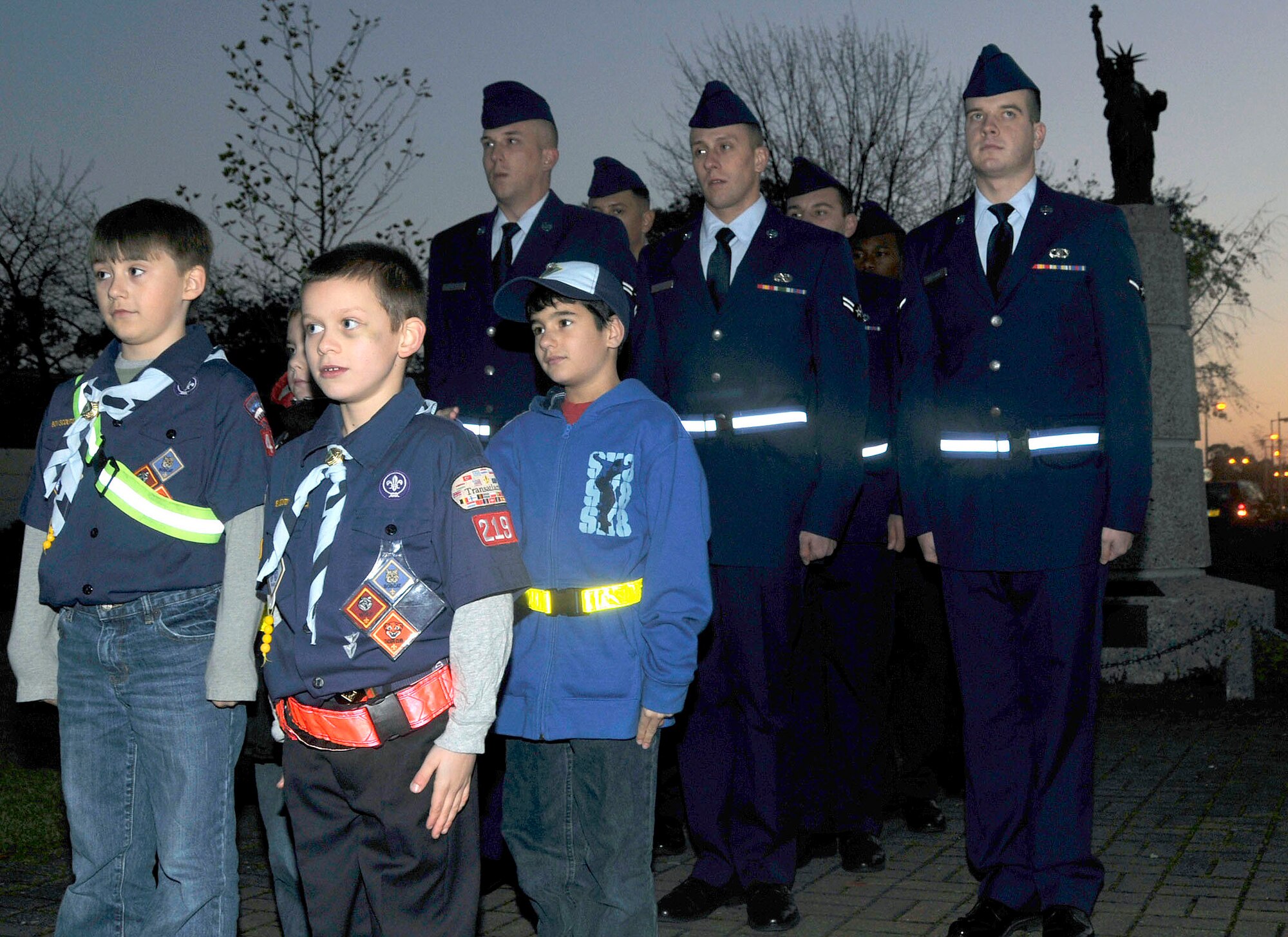 Cub Scouts and Airmen from the First Term Airmen Center form up and await further instructions before retreat sounds at RAF Lakenheath, England, Nov. 9. The Cub Scouts were part of the retreat ceremony that included a formation of their own. The retreat ceremony was chosen by the Cub Scouts as their community service project.   (U.S. Air Force photo/Airman 1st Class Eboni Knox)