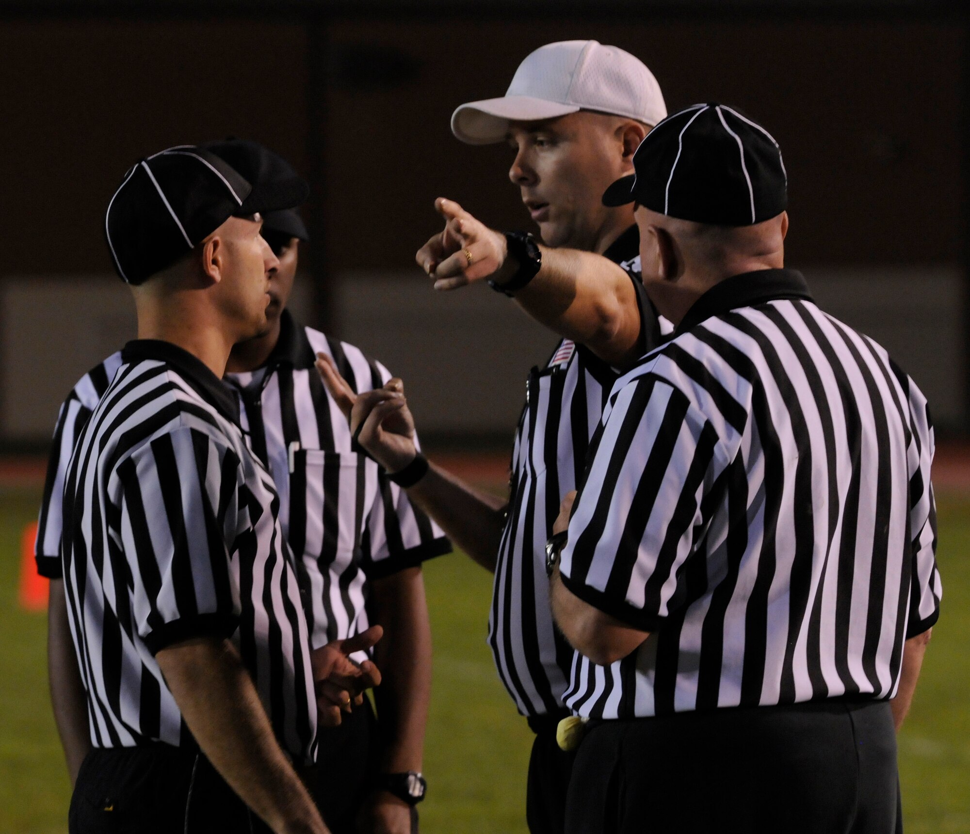 Referees discuss the flags thrown on a certain play during a semi-final intramural flag football game at the Incirlik football field, Wednesday, Nov. 11, 2009. The winning team proceeded to the intramural championship game. The 728th AMS defeated the 39th SFS 19 to 14. (U.S. Air Force photo/Airman 1st Class Amber Ashcraft)