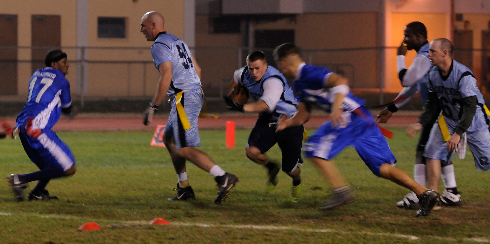 As teammates attempt to protect him, Senior Airman David Webb, 39th Security Forces Squadron, rushes past members of 728th Air Mobility Squadron during a semi-final intramural flag football game at the Incirlik football field, Wednesday, Nov. 11, 2009. The winning team proceeded to the intramural championship game. The 728th AMS defeated the 39th SFS 19 to 14. (U.S. Air Force photo/Airman 1st Class Amber Ashcraft)
