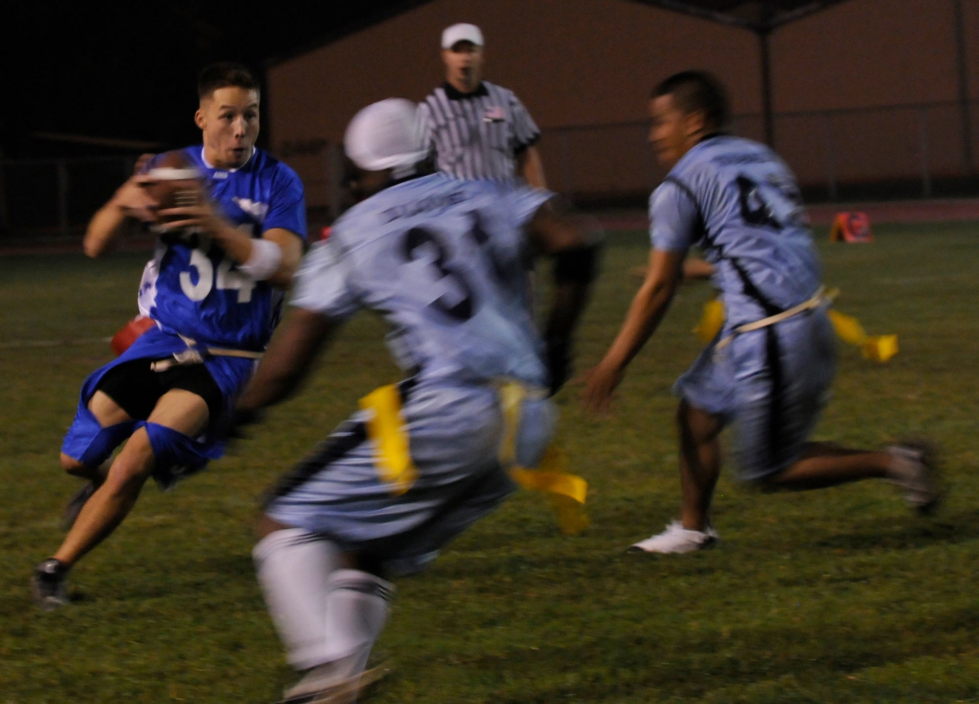 Senior Airman Danny Hagglund, 728th Air Mobility Squadron, attempts to pass members of 39th Security Forces Squadron during a semi-final intramural flag football game at the Incirlik football field, Wednesday, Nov. 11, 2009. The winning team proceeded to the intramural championship game. The 728th AMS defeated the 39th SFS 19 to 14. (U.S. Air Force photo/Airman 1st Class Amber Ashcraft)