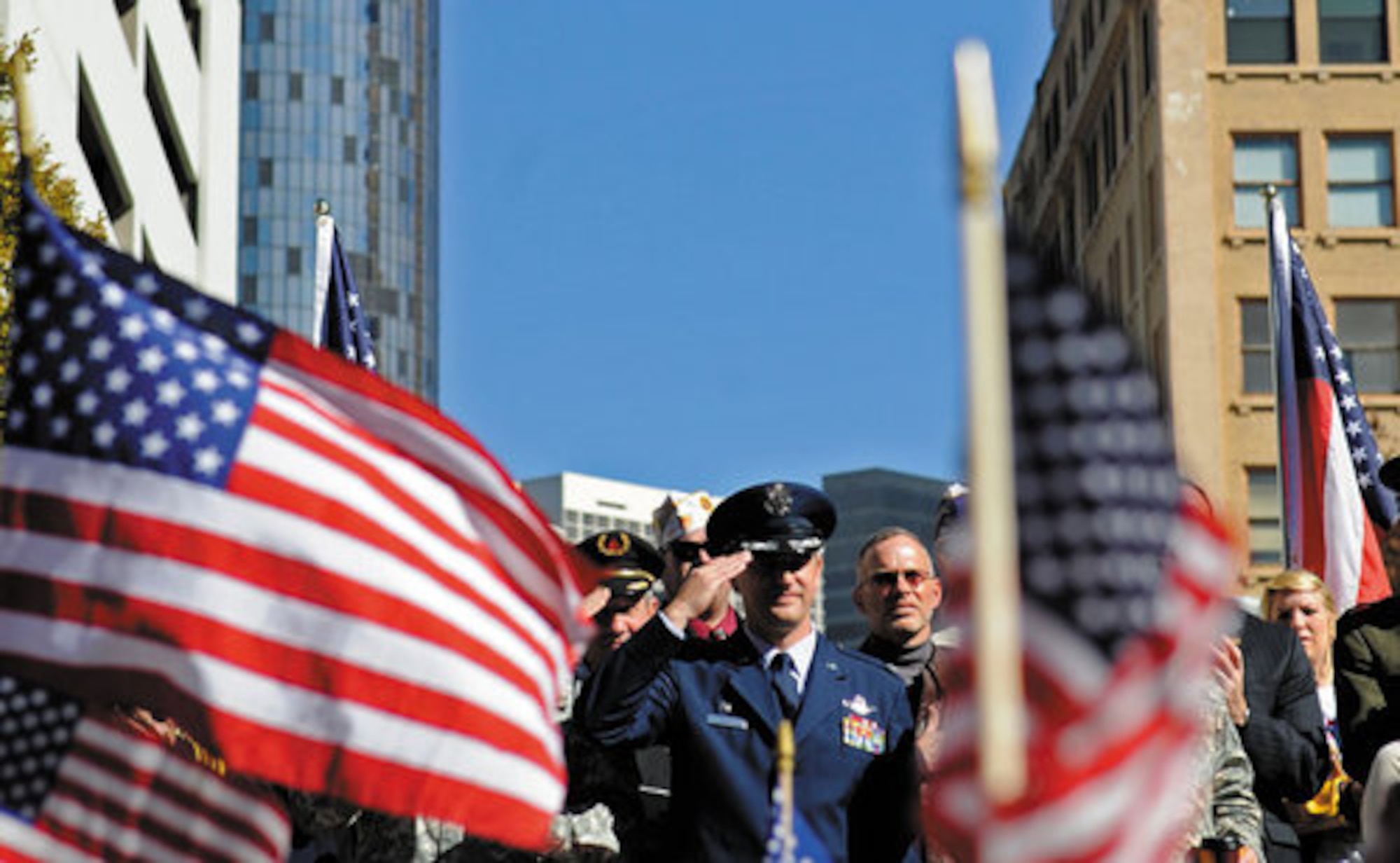 Col. Heath Nuckolls, Commander of the 94th Airlift Wing, salutes participants of the Georgia Veteran's Day parade in downtown Atlanta Nov. 7. (Courtesy Photo)