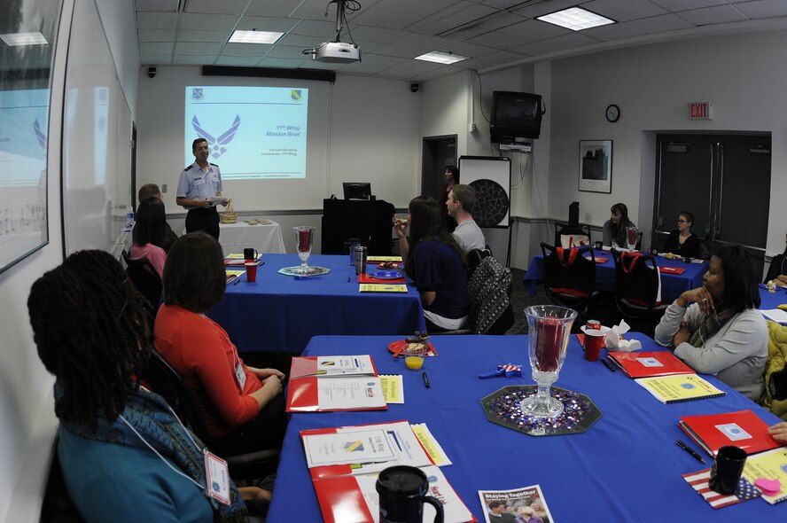 Col. Carl Gramlick, 11th Wing commander, briefs Air Force spouses at a Heart Link seminar Nov. 7 at the Bolling Air Force Base Airman and Family Readiness Center. Heart Link is designed to help military spouses learn how the Air Force works and the important role spouses play on the Air Force team with presentations from protocol, the military personnel flight, finance, AFRC, services, legal, the health and wellness center, family advocacy, Tricare, the 11th Wing chaplaincy, the 11th Mission Support Squadron first sergeant and mental health. The AFRC typically offers the Heart Link program twice a year. (U.S. Air Force photo by Senior Airman Alexandre Montes)