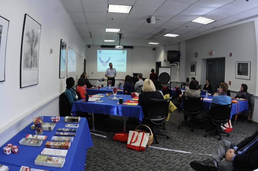 Col. Carl Gramlick, 11th Wing commander, briefs Air Force spouses at a Heart Link seminar Nov. 7 at the Bolling Air Force Base Airman and Family Readiness Center. Heart Link is designed to help military spouses learn how the Air Force works and the important role spouses play on the Air Force team with presentations from protocol, the military personnel flight, finance, AFRC, services, legal, the health and wellness center, family advocacy, Tricare, the 11th Wing chaplaincy, the 11th Mission Support Squadron first sergeant and mental health. The AFRC typically offers the Heart Link program twice a year. (U.S. Air Force photo by Senior Airman Alexandre Montes)