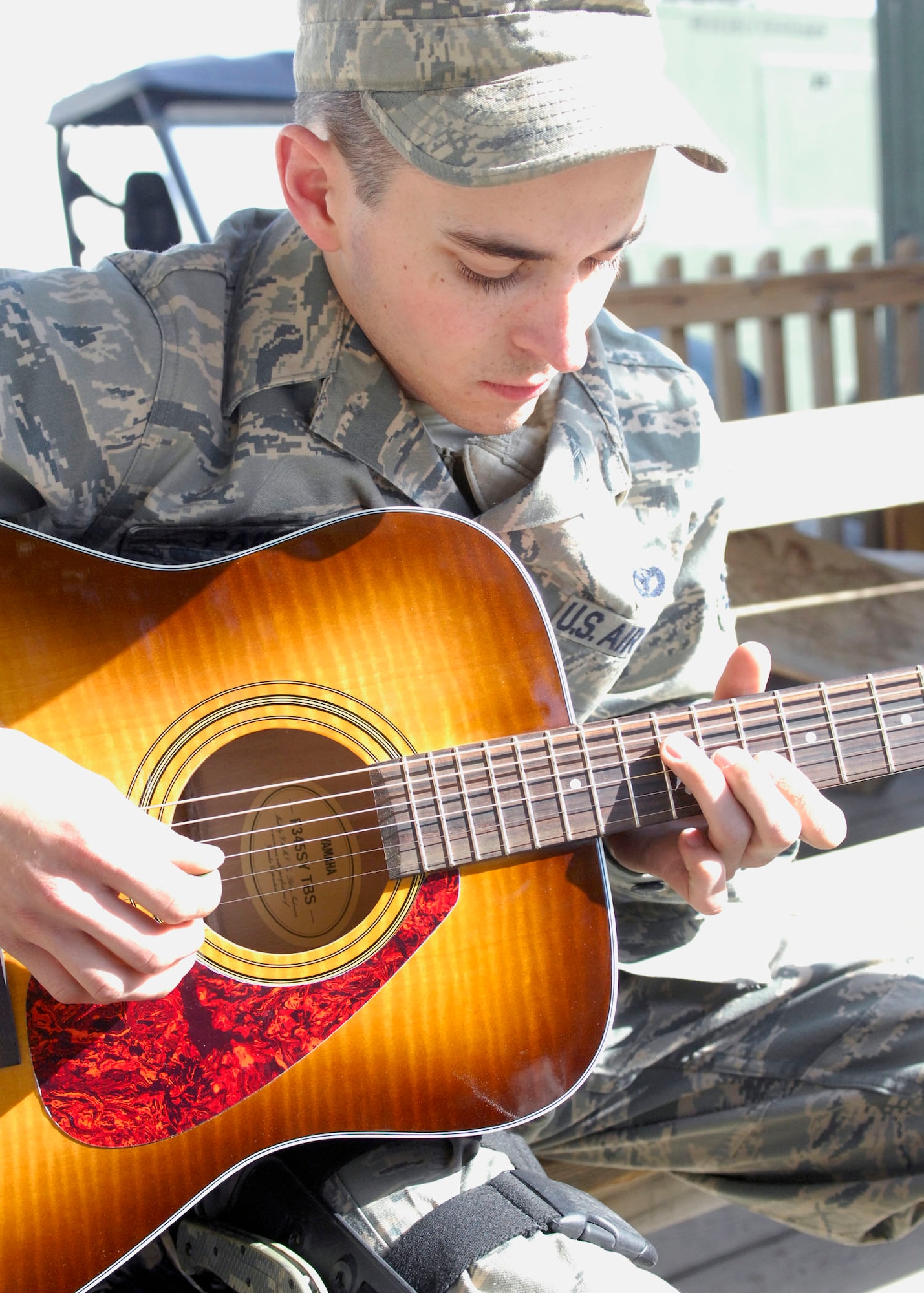 BAGRAM AIRFIELD, Afghanistan -- Airman 1st Class Nicholas Paine, a Security Forces Airman deployed from Hill Air Force Base, Utah, takes a break from his busy schedule to play a couple of his favorite songs, Nov. 12, 2009. The youngest of four brothers, Airman Paine started playing the guitar when he received one as a Christmas gift in 2003. He likes to play acoustic soft rock, and learns how to play songs by listening to them once or twice. Airman Paine is originally from Camano Island, Wash., and is deployed with the 455th Expeditionary Security Forces Squadron. (U.S. Air Force photo/Senior Airman Susan Tracy) 