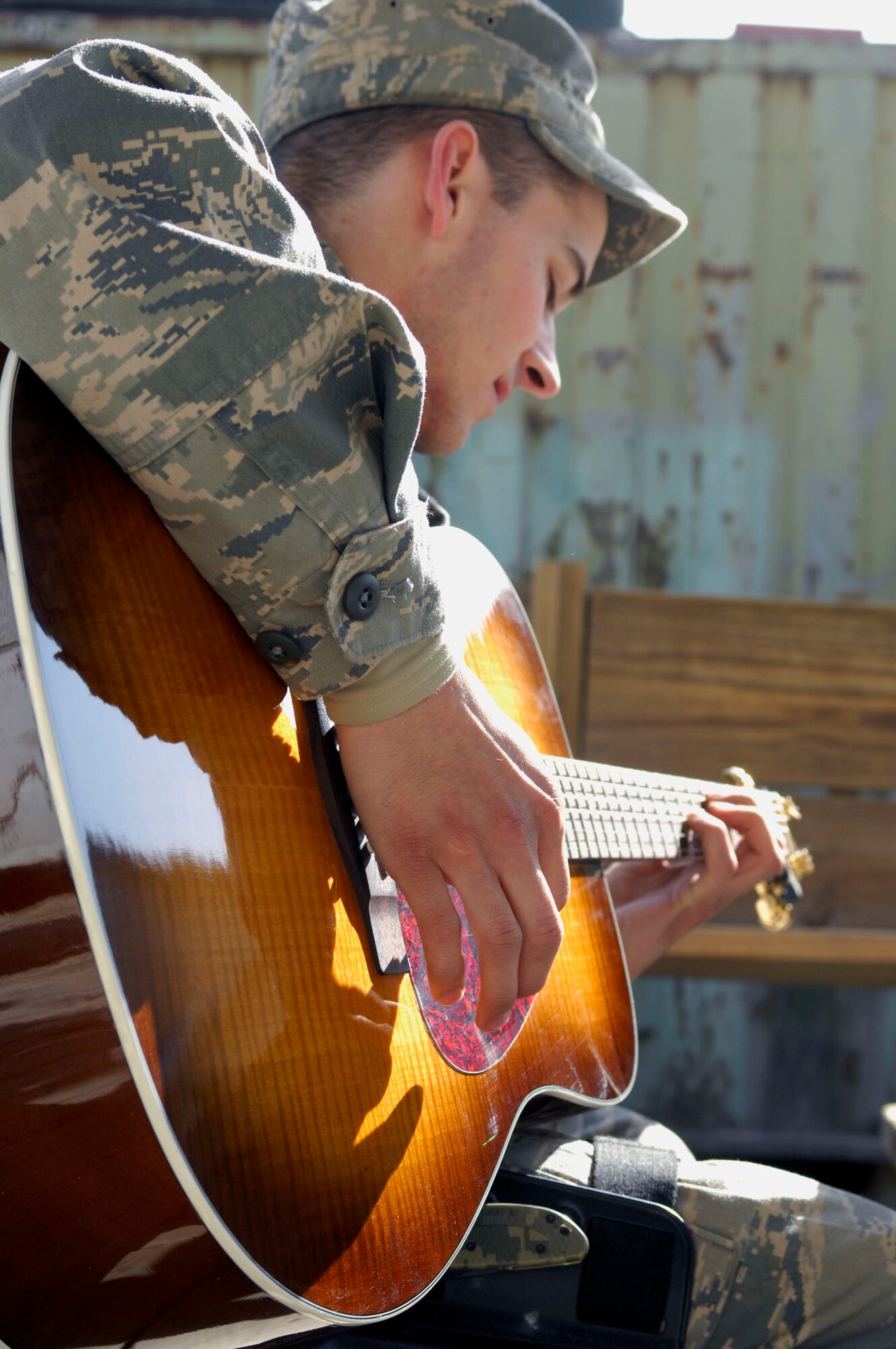 BAGRAM AIRFIELD, Afghanistan -- Airman 1st  Class Nicholas Paine, a Security Forces Airman deployed from Hill Air Force Base, Utah, takes a break from his busy schedule to play a couple of his favorite songs, Nov. 12, 2009. The youngest of four brothers, Airman Paine started playing the guitar when he received one as a Christmas gift in 2003. He is originally from Camano Island, Wash., and is deployed with the 455th Expeditionary Security Forces Squadron. (U.S. Air Force photo/Senior Airman Susan Tracy) 