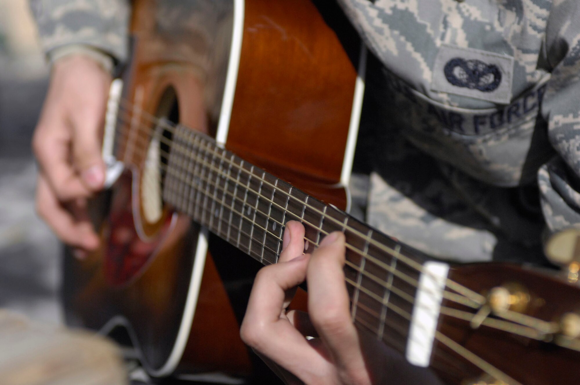 BAGRAM AIRFIELD, Afghanistan -- Airman 1st Class Nicholas Paine, a Security Forces Airman deployed from Hill Air Force Base, Utah, takes a break from his busy schedule to play a couple of his favorite songs, Nov. 12, 2009. The youngest of four brothers, Airman Paine started playing the guitar when he received one as a Christmas gift in 2003. He likes to play acoustic soft rock, and learns how to play songs by listening to them once or twice. Airman Paine is originally from Camano Island, Wash., and is deployed with the 455th Expeditionary Security Forces Squadron. (U.S. Air Force photo/Senior Airman Susan Tracy) 