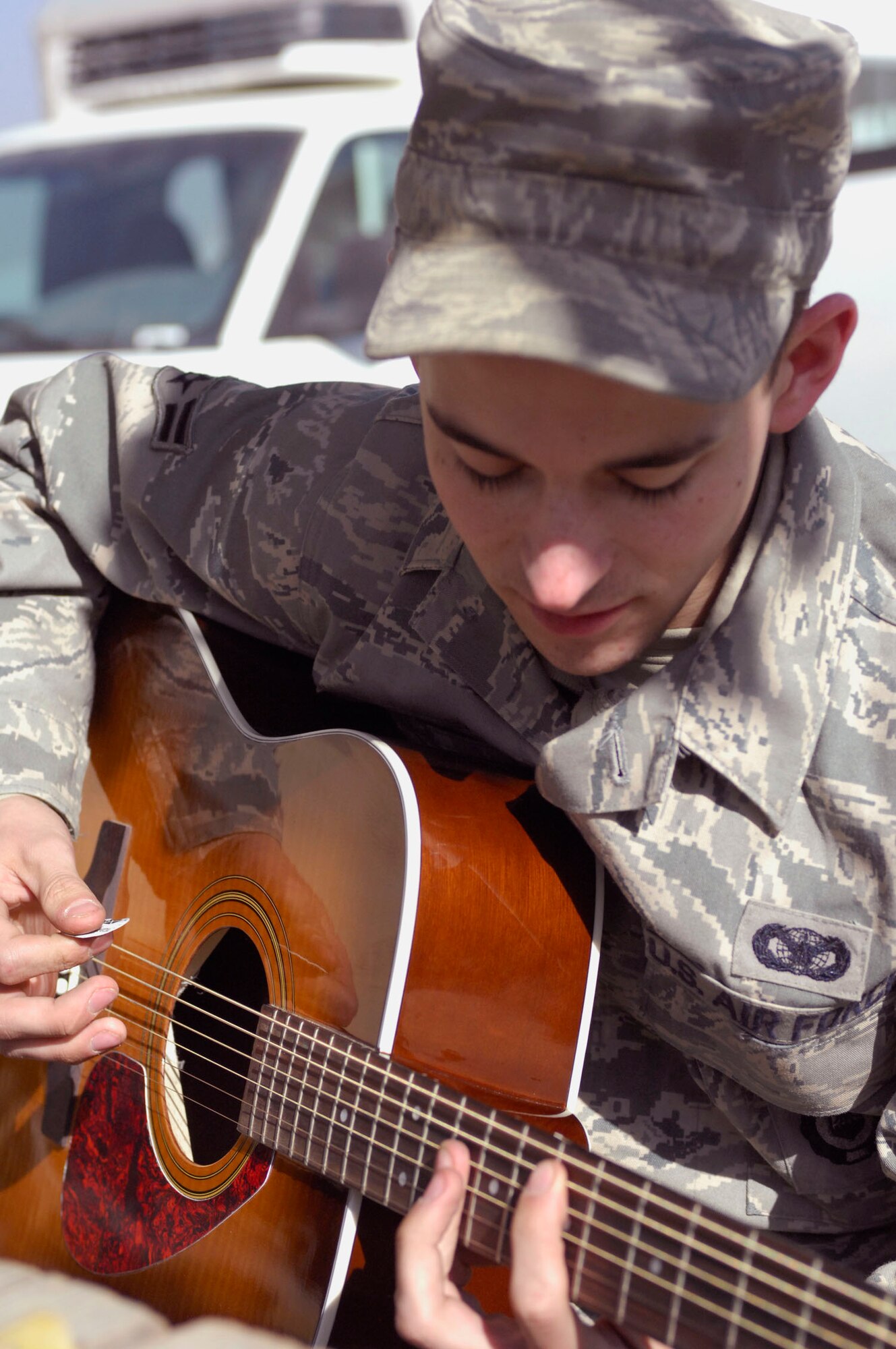 BAGRAM AIRFIELD, Afghanistan -- Airman 1st Class Nicholas Paine, a Security Forces Airman deployed from Hill Air Force Base, Utah, takes a break from his busy schedule to play a couple of his favorite songs, Nov. 12, 2009. The youngest of four brothers, Airman Paine started playing the guitar when he received one as a Christmas gift in 2003. He has never taken any lessons in the six years he’s been playing; most of the time Airman Paine can figure out how to play a song simply by listening to it, two or three times. He is originally from Camano Island, Wash., and is deployed with the 455th Expeditionary Security Forces Squadron. (U.S. Air Force photo/Senior Airman Susan Tracy) 
