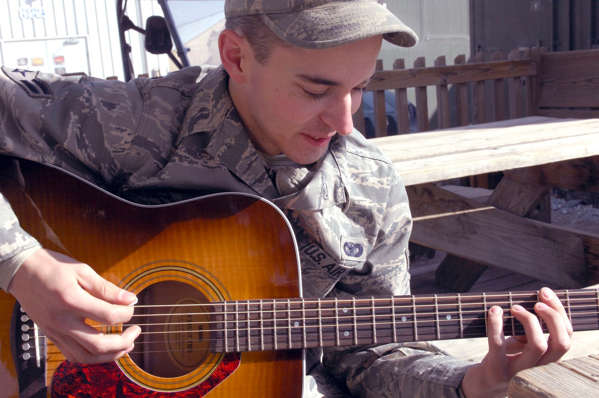 BAGRAM AIRFIELD, Afghanistan -- Airman 1st  Class Nicholas Paine, a Security Forces Airman deployed from Hill Air Force Base, Utah, takes a break from his busy schedule to play a couple of his favorite songs, Nov. 12, 2009. The youngest of four brothers, Airman Paine started playing the guitar when he received one as a Christmas gift in 2003. He is originally from Camano Island, Wash., and is deployed with the 455th Expeditionary Security Forces Squadron. (U.S. Air Force photo/Senior Airman Susan Tracy) 