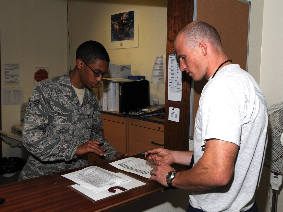 Senior Airman Anson Orr, 379th Expeditionary Comptroller Squadron customer service technician, assists a customer with military pay entitlements at a deployed location in Southwest Asia, Nov. 12, 2009. The 379 ECPTS handles all military pay issues for deployed members, as well as managing the budget for the 379th Air Expeditionary Wing. Airman Orr is deployed from Ellsworth Air Force Base, S.D. in support of operations Iraqi Freedom and Enduring Freedom. (U.S. Air Force Photo/Tech. Sgt. Jason W. Edwards)