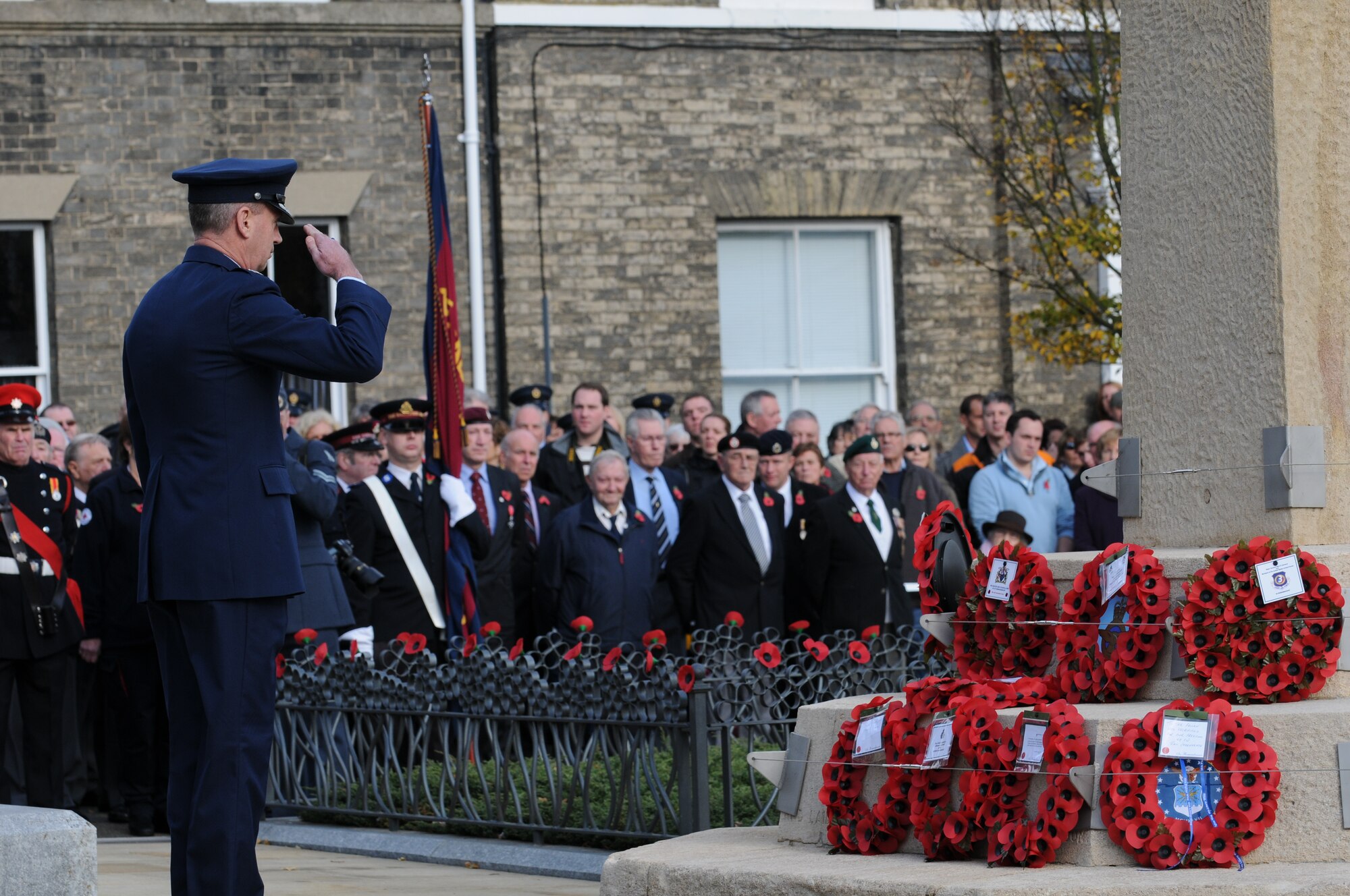 ROYAL AIR FORCE LAKENHEATH, England -- Col. Lawrence Reed, 48th Fighter Wing vice commander, salutes poppy wreaths at a remembrance ceremony Nov. 8, at Angel Hill, Bury St. Edmunds. Servicemembers from RAFs Lakenheath and Mildenhall participated in a military procession with British forces before the ceremony. The poppy flower is a traditional symbol of remembrance of World War I. It was in bloom across some of the worst battlefields in the war. (U.S. Air Force photo/Senior Airman Thomas Trower)