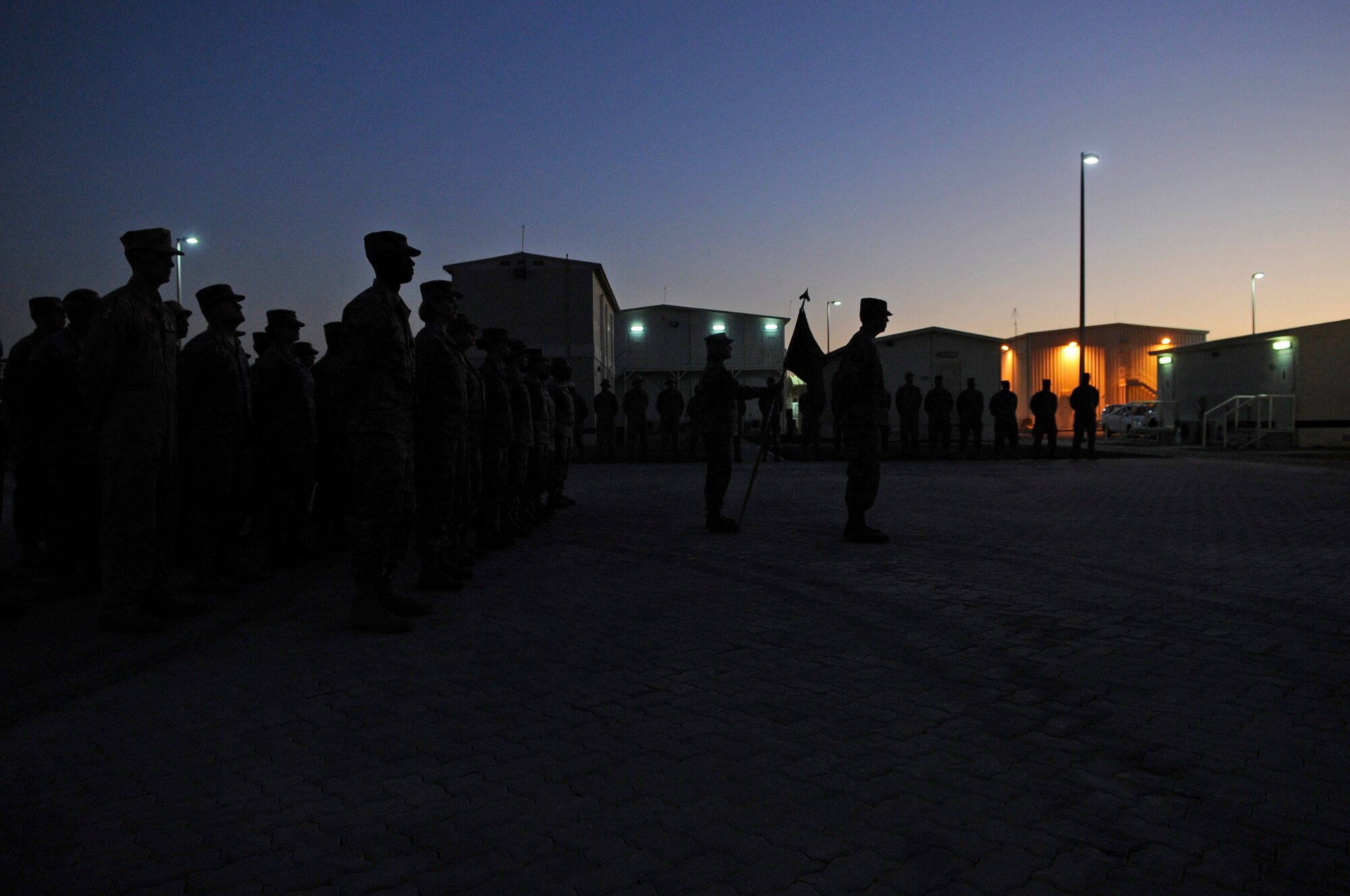 SOUTHWEST ASIA - Members of the 380th Air Expeditionary Wing stand in formation during a Retreat ceremony honoring Veterans Day, Nov. 11, 2009. Veterans Day, formerly known as Armistice Day, was originally set as a U.S. legal holiday to honor the end of World War I, which officially took place on November 11, 1918. (U.S. Air Force photo/Senior Airman Stephen Linch)