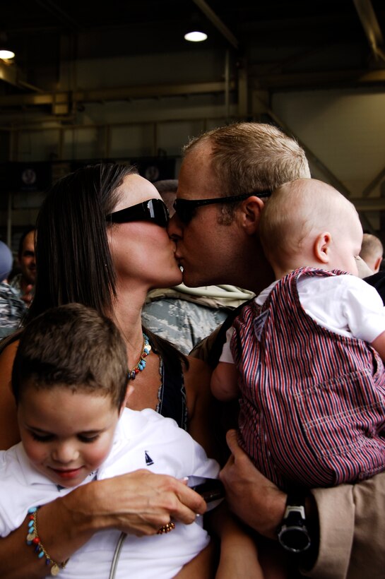 U.S. Air Force Capt. Charles Lowry kisses his wife during Operation Homecoming June 5, 2009, at Hurlburt Field, Fla., after returning from a deployment. Operation Homecoming is a ceremony dedicated to supporting men and women returning from deployments overseas. Lowry is assigned to the 4th Special Operations Squadron.