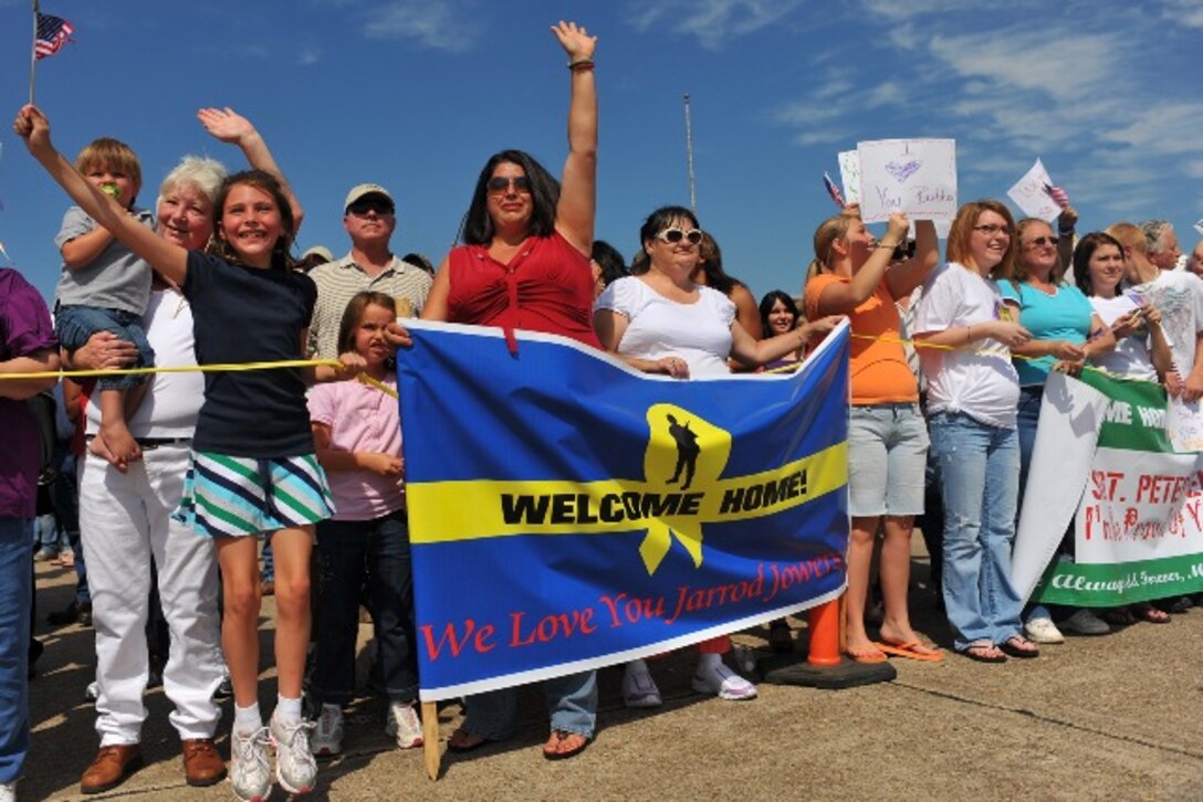 Friends and family members of the Louisiana Army National Guard’s 39th Military Police Company, 773rd Military Police Battalion, of Minden, La., wave flags and signs for loved ones returning from a year long deployment during a homecoming reception at the Shreveport Regional Airport in Shreveport, La., Sept. 26, 2009. The 39th Military Police Company deployed in support of Operation Iraqi Freedom in 2008.