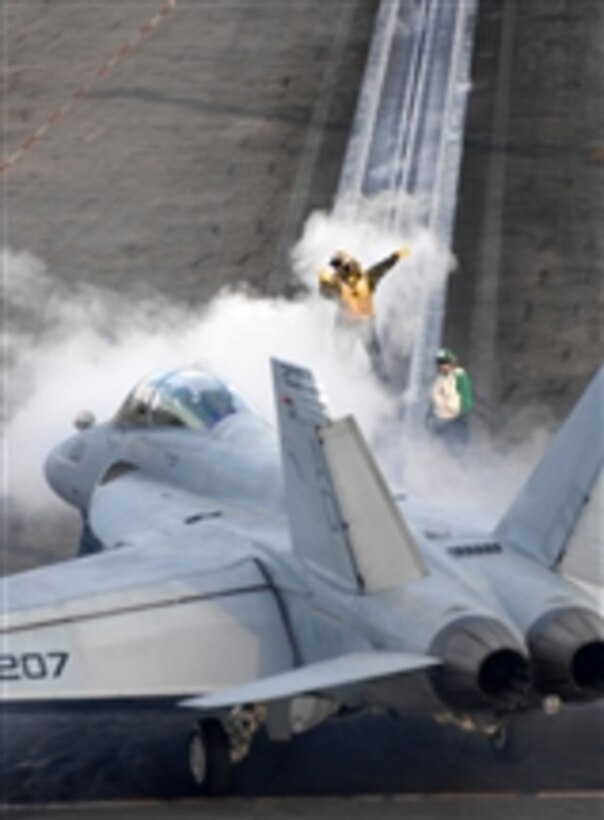 U.S. Navy flight deck personnel direct an F/A-18C Hornet aircraft assigned to Strike Fighter Squadron 106 to the steam powered catapults aboard the aircraft carrier USS Harry S. Truman (CVN 75) in preparation for a launch in the Atlantic Ocean on Nov. 4, 2009.  The Truman is underway conducting carrier qualifications.  