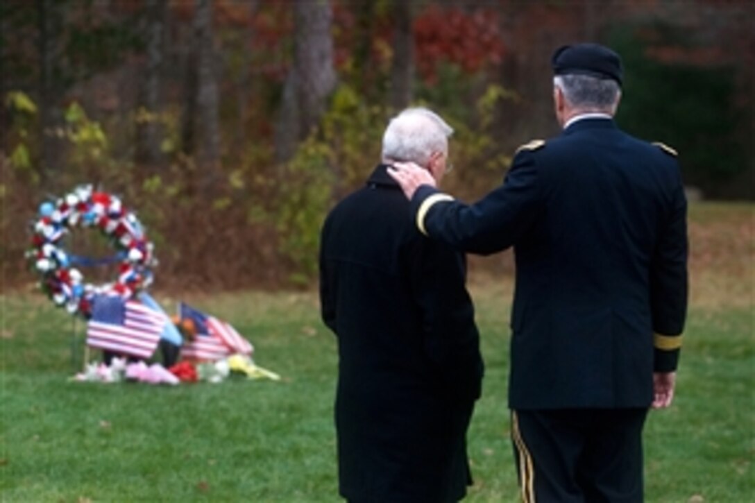 Paul Monti, left, the father of Medal of Honor recipient U.S. Army Sgt. 1st Class Jared C. Monti, and Army Chief of Staff Gen. George W. Casey Jr. stand near Monti's burial site on Veterans Day at the Massachusetts National Ceremony in Bourne, Mass., Nov. 11, 2009. Sgt. 1st Class Monti was posthumously awarded the Medal of Honor, Sept. 17, 2009, after being killed in action by insurgent fire in Afghanistan when he attempted to rescue a wounded soldier.